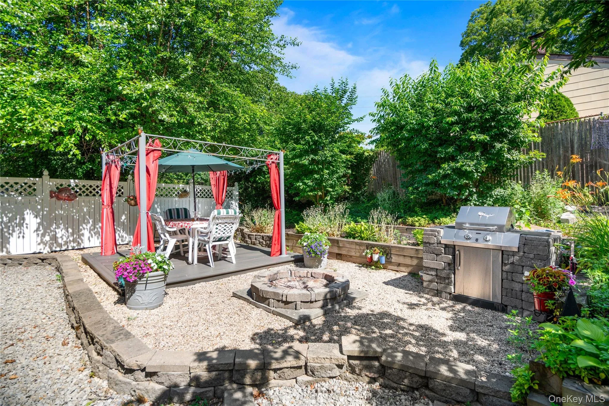 12' x 12' platform structure featuring a stone built-in BBQ and a custom fire pit. 12' x 12' platform structure featuring a stone built-in BBQ and a custom fire pit.