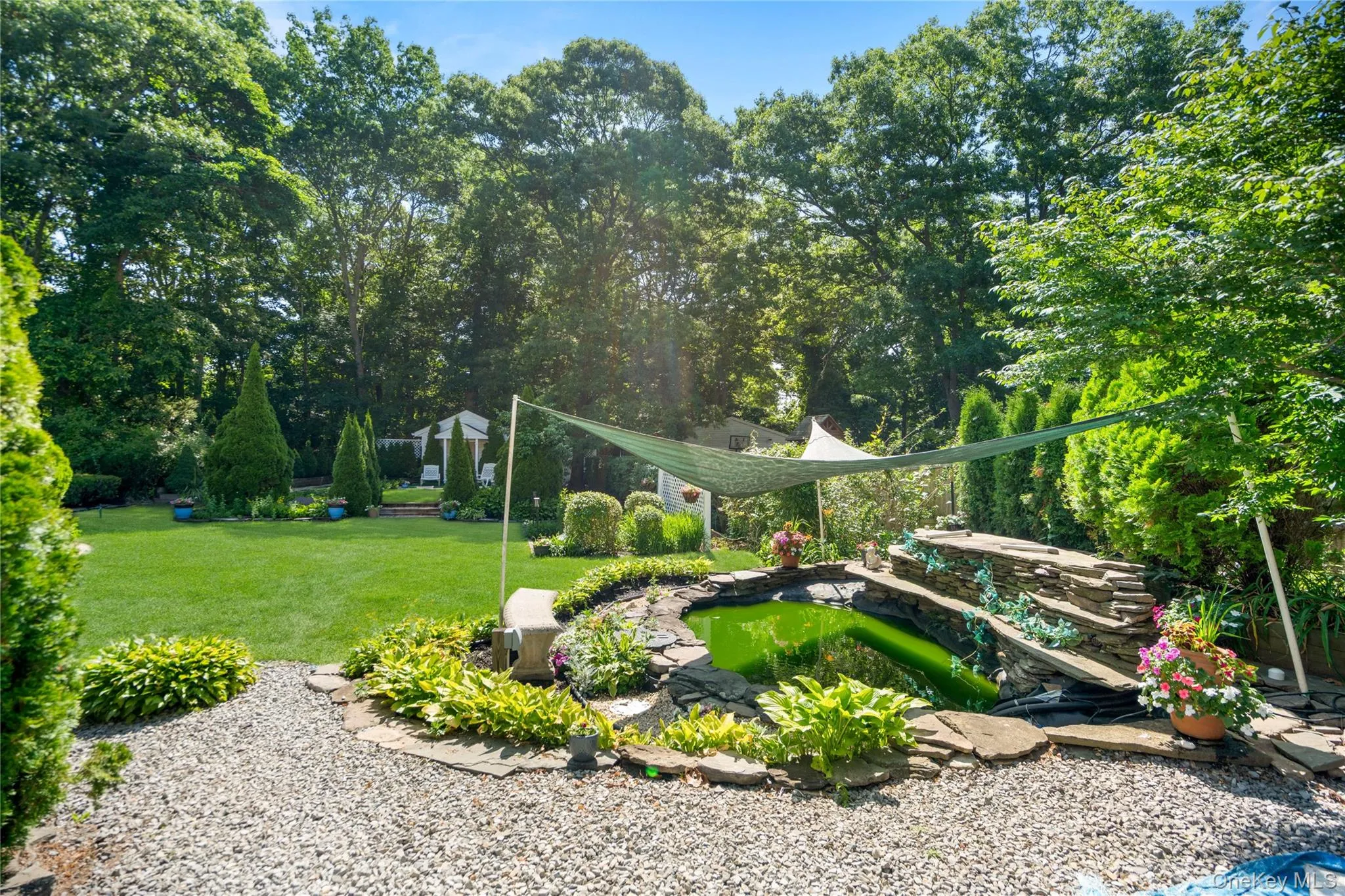 Koi pond with a three-level waterfall, full plumbing and filtration system, and a covered design complete with a dedicated viewing bench. Koi pond with a three-level waterfall, full plumbing and filtration system, and a covered design complete with a dedicated viewing bench.
