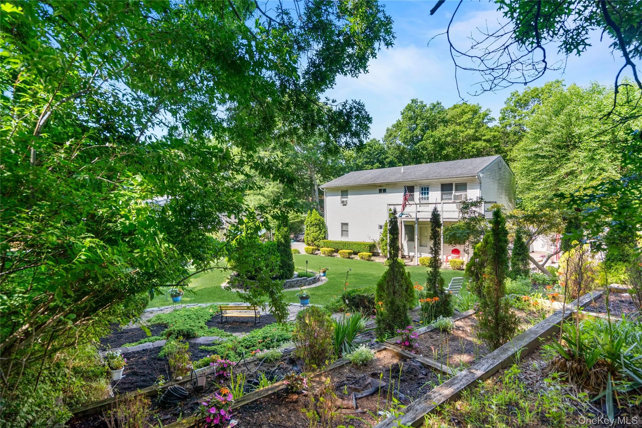 Three-tier terrace garden beds with layered shrubs and a charming park bench create a beautiful, structured outdoor retreat. Three-tier terrace garden beds with layered shrubs and a charming park bench create a beautiful, structured outdoor retreat.
