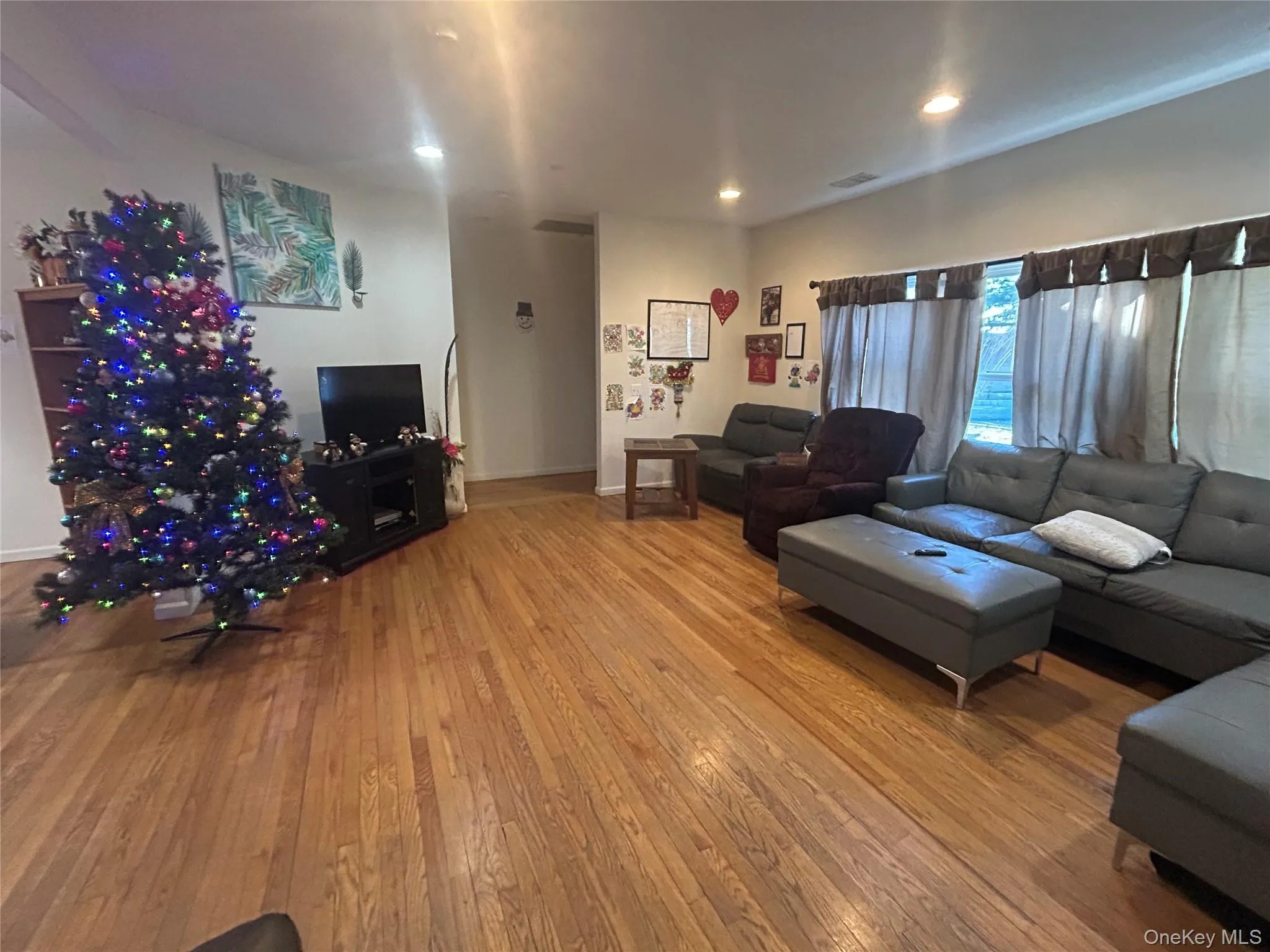 Living room with hardwood / wood-style floors and recessed lighting Living room with hardwood / wood-style floors and recessed lighting