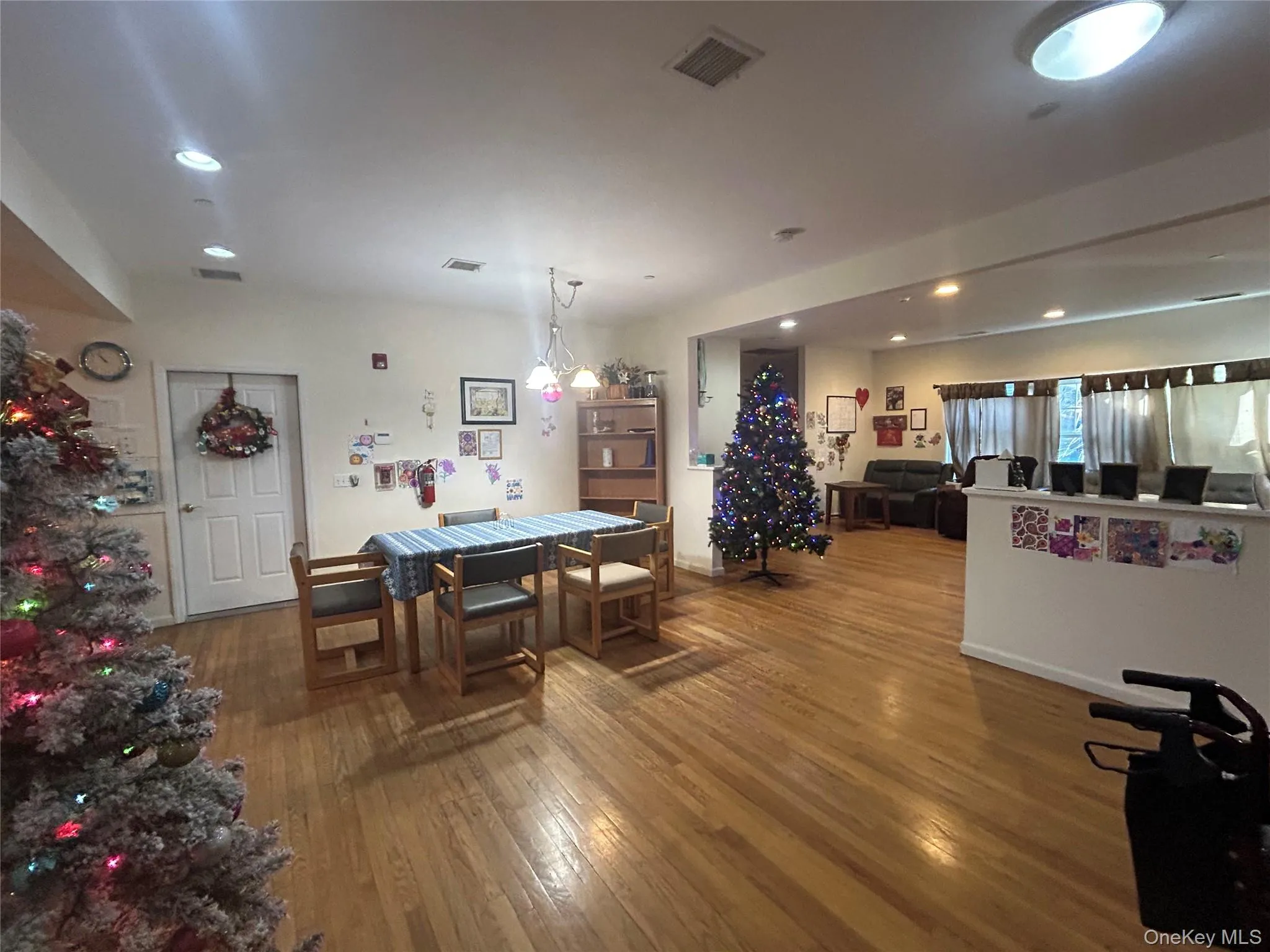 Dining room with dark wood-style floors and recessed lighting Dining room with dark wood-style floors and recessed lighting