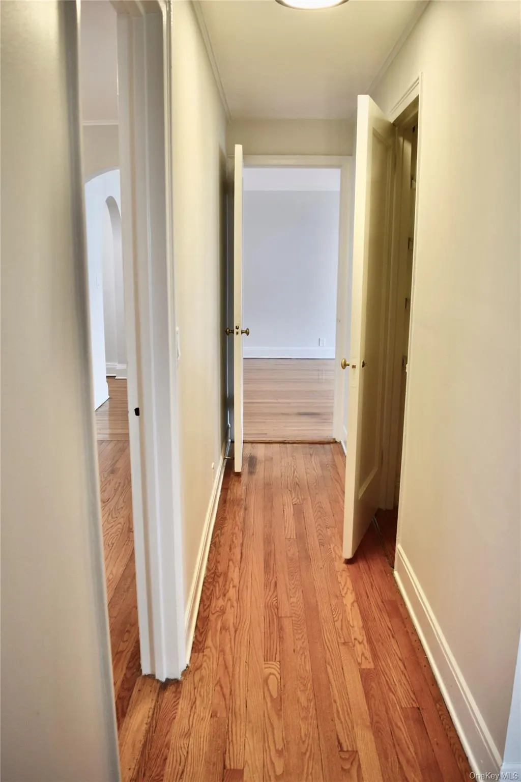 Hallway connecting living room to bedrooms with guest bathroom and linen closet. Hallway connecting living room to bedrooms with guest bathroom and linen closet.
