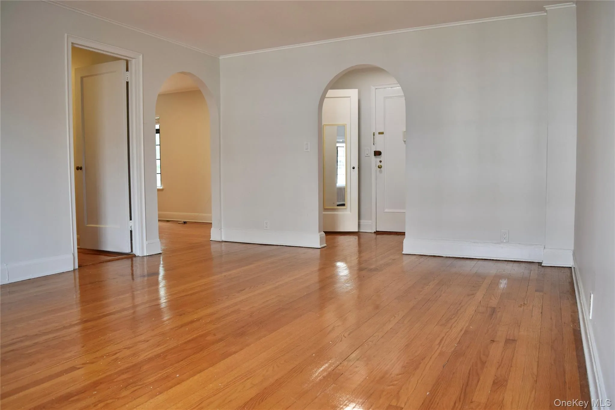 Living Room with arched passageways to entry and dining/kitchen rooms. Living Room with arched passageways to entry and dining/kitchen rooms.