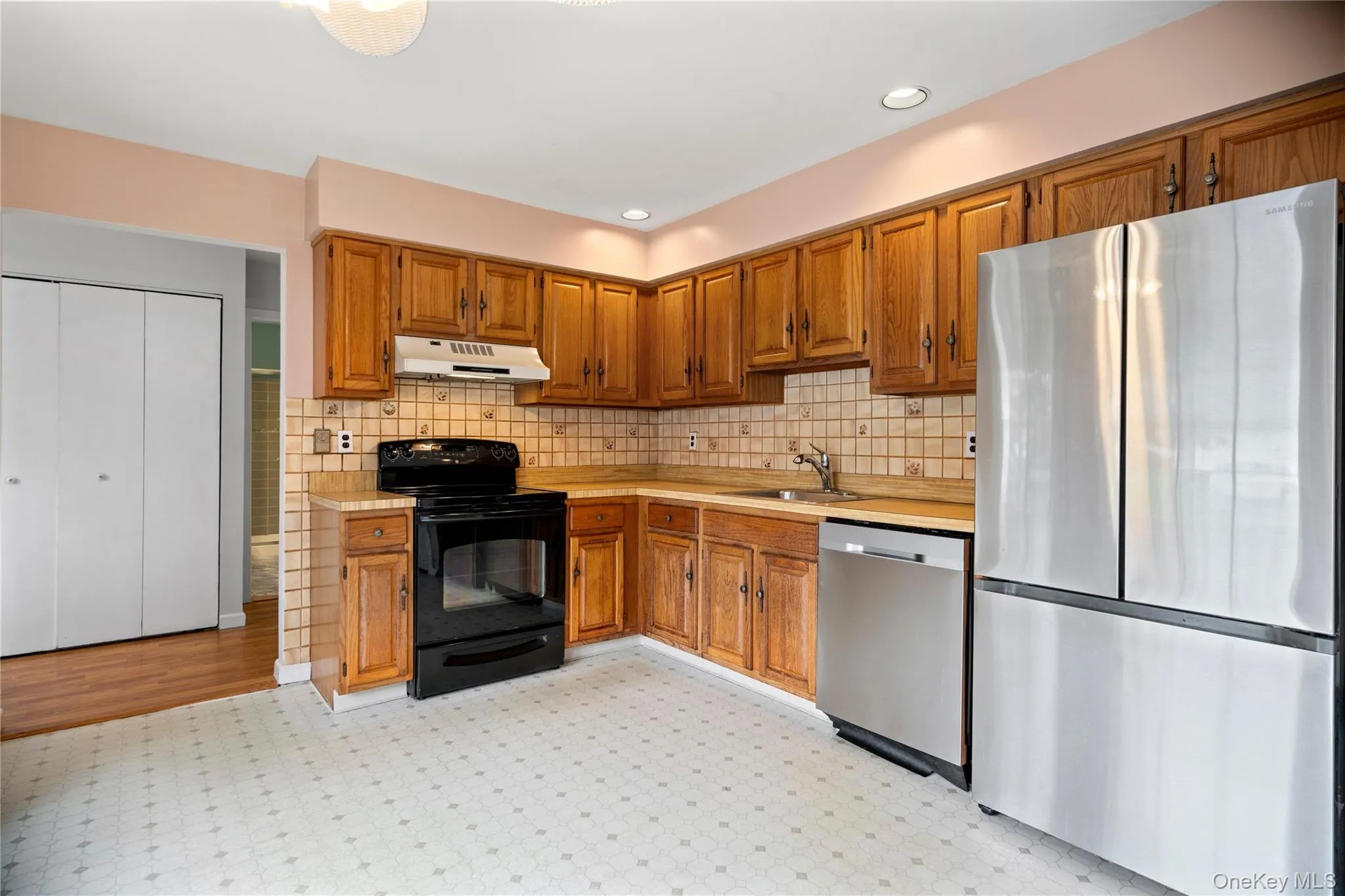 Eat in kitchen with wood cabinets and tile backsplash. Eat in kitchen with wood cabinets and tile backsplash.