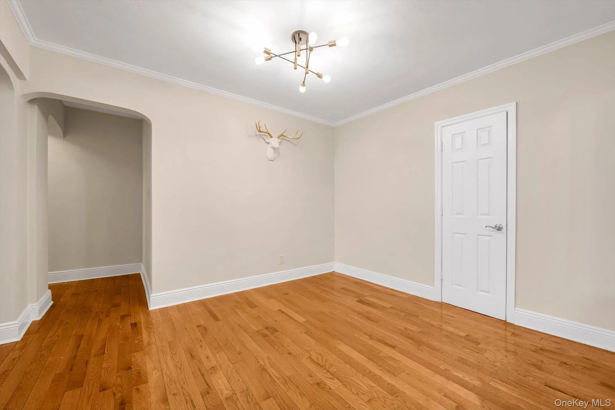 Hallway leading to ensuite primary bedroom, 2nd bedroom and full bath Hallway leading to ensuite primary bedroom, 2nd bedroom and full bath