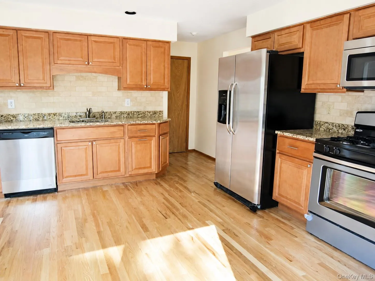 The updated eat in kitchen has lots of wood cabinets, granite counters, stainless steel appliance and beautful oak floors. The updated eat in kitchen has lots of wood cabinets, granite counters, stainless steel appliance and beautful oak floors.