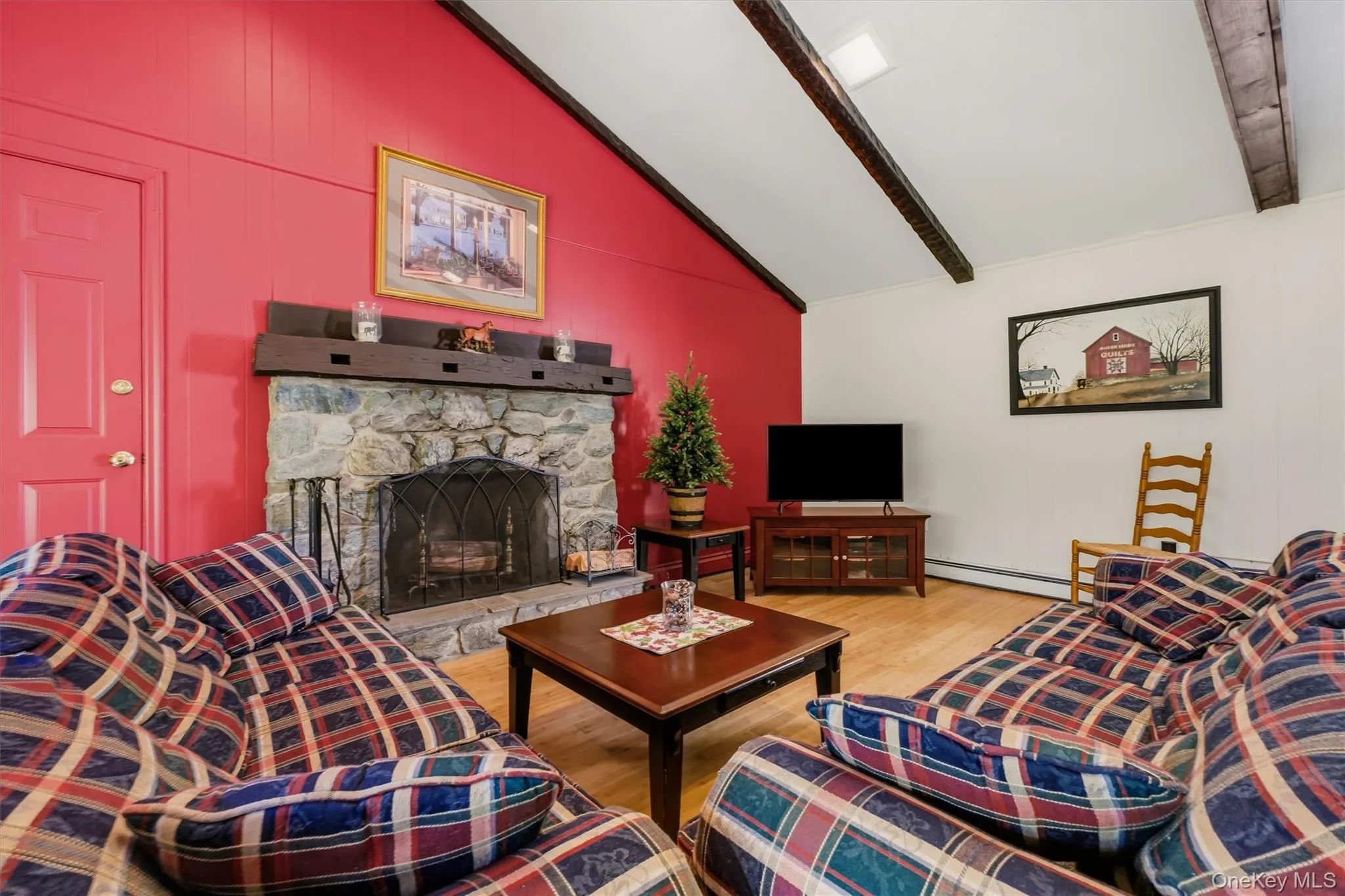 Enormous family room with beamed, cathedral ceiling, bamboo floors, large bay window and stone fireplace Enormous family room with beamed, cathedral ceiling, bamboo floors, large bay window and stone fireplace