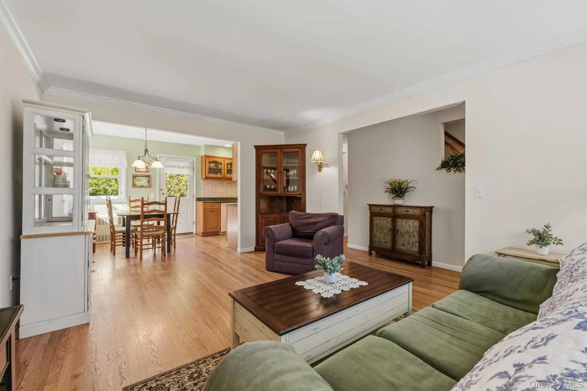 Living room features crown molding, picture window and hardwood floors Living room features crown molding, picture window and hardwood floors