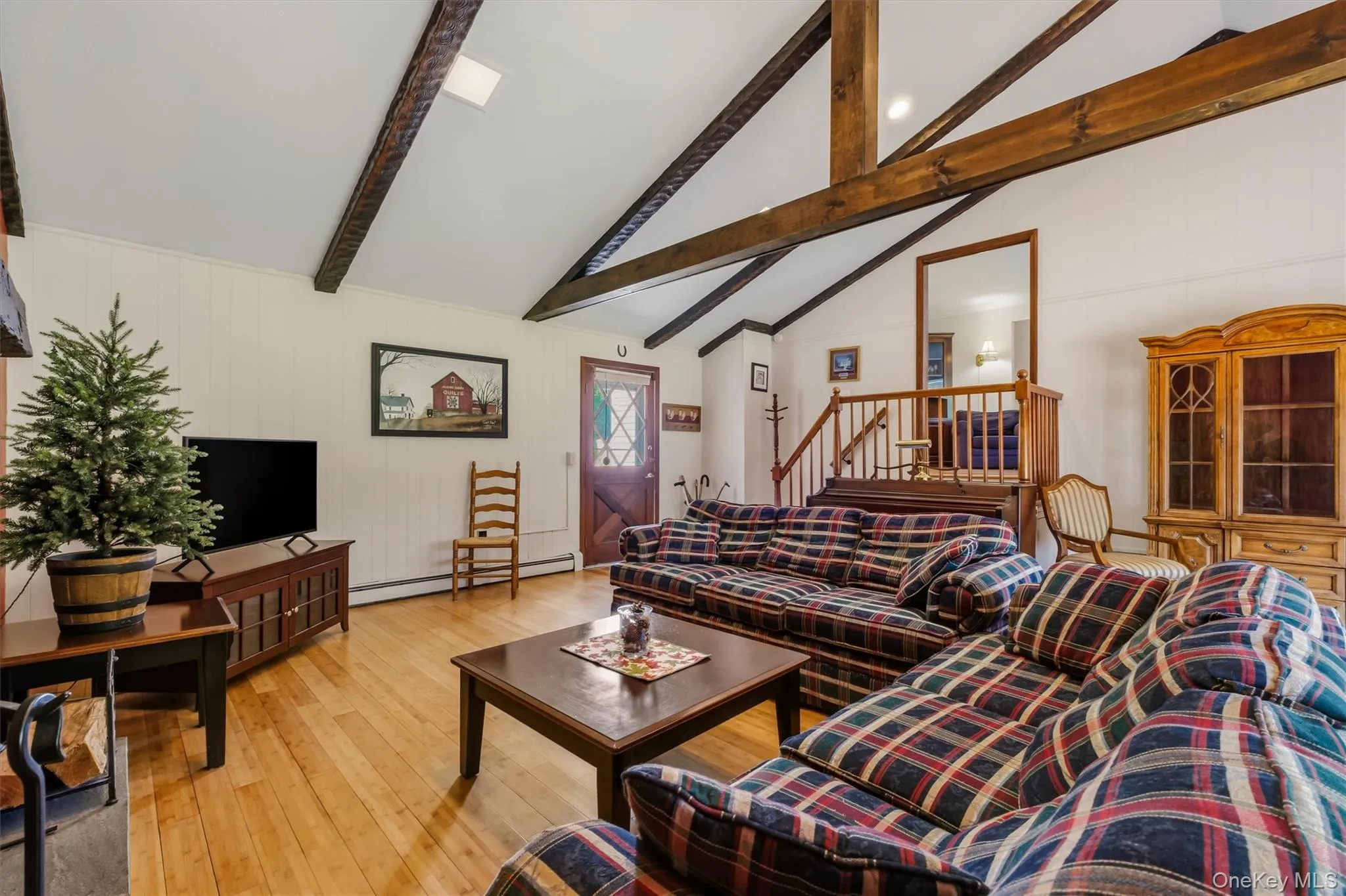 Enormous family room with beamed, cathedral ceiling, bamboo floors, large bay window and stone fireplace Enormous family room with beamed, cathedral ceiling, bamboo floors, large bay window and stone fireplace