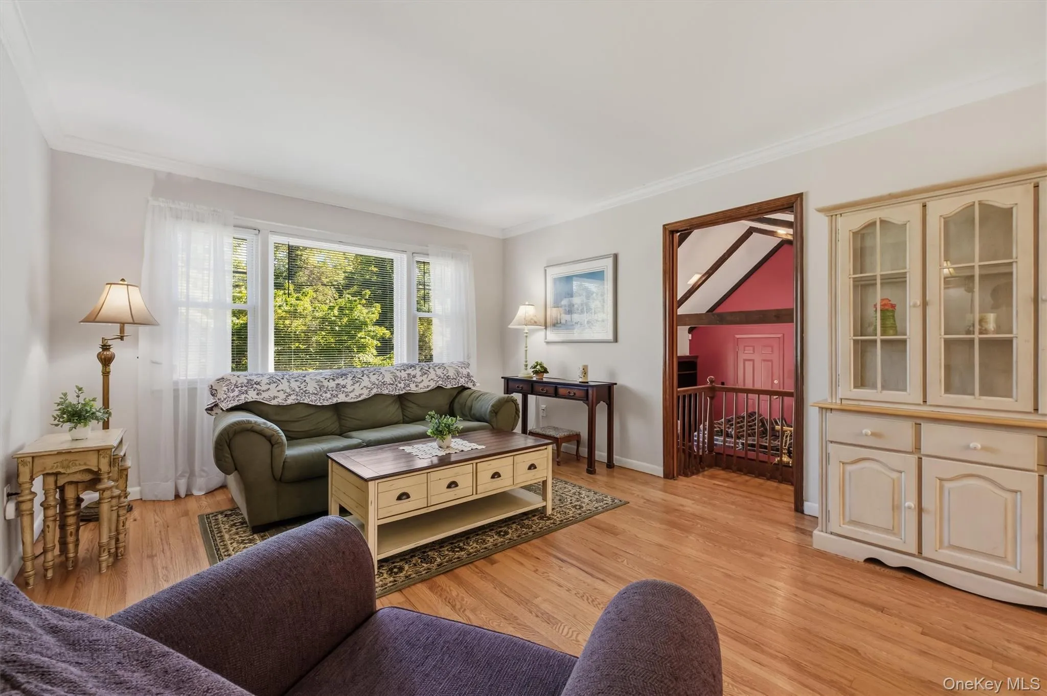 Living room features crown molding, picture window and hardwood floors Living room features crown molding, picture window and hardwood floors