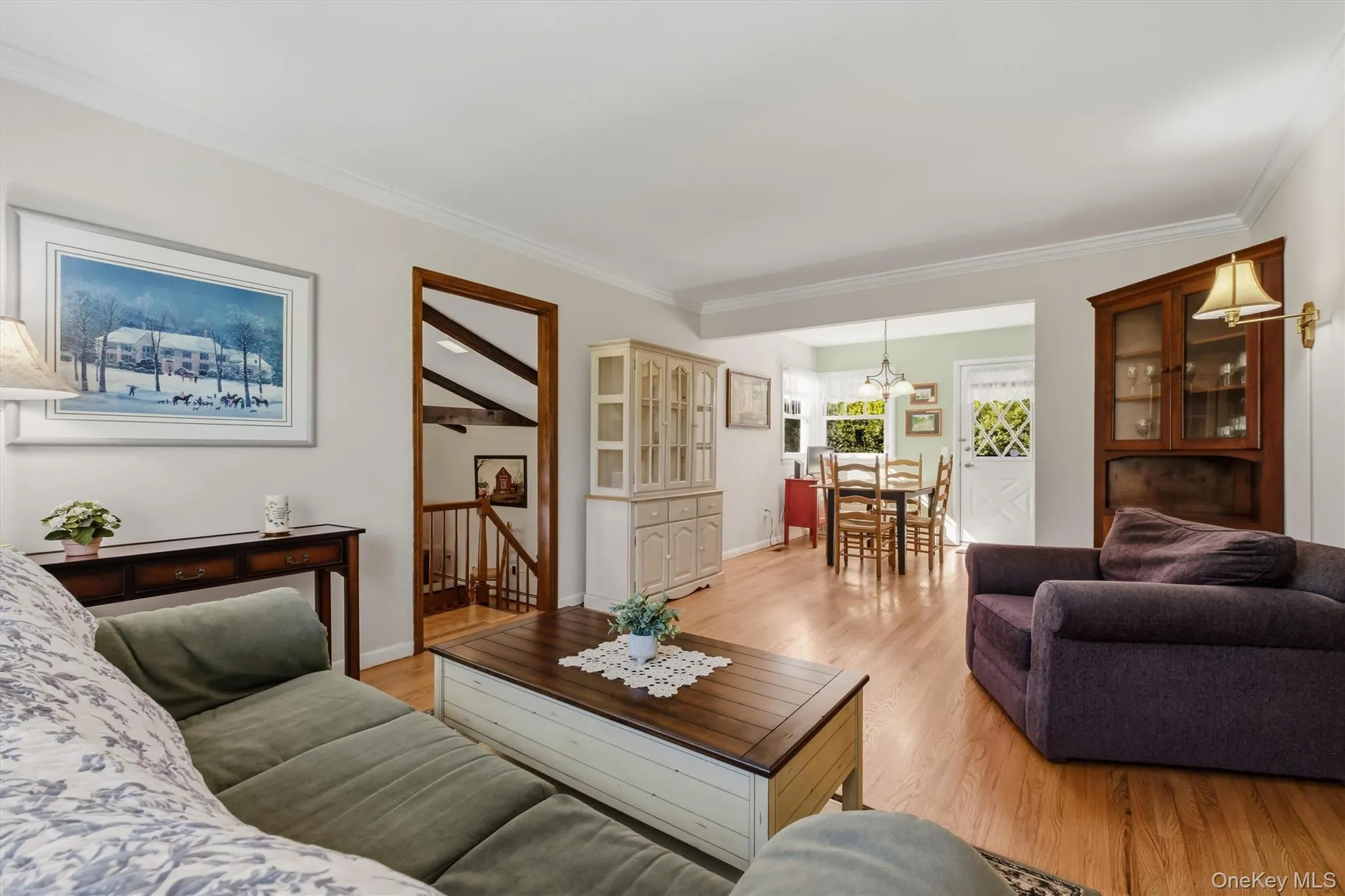 Living room features crown molding, picture window and hardwood floors Living room features crown molding, picture window and hardwood floors