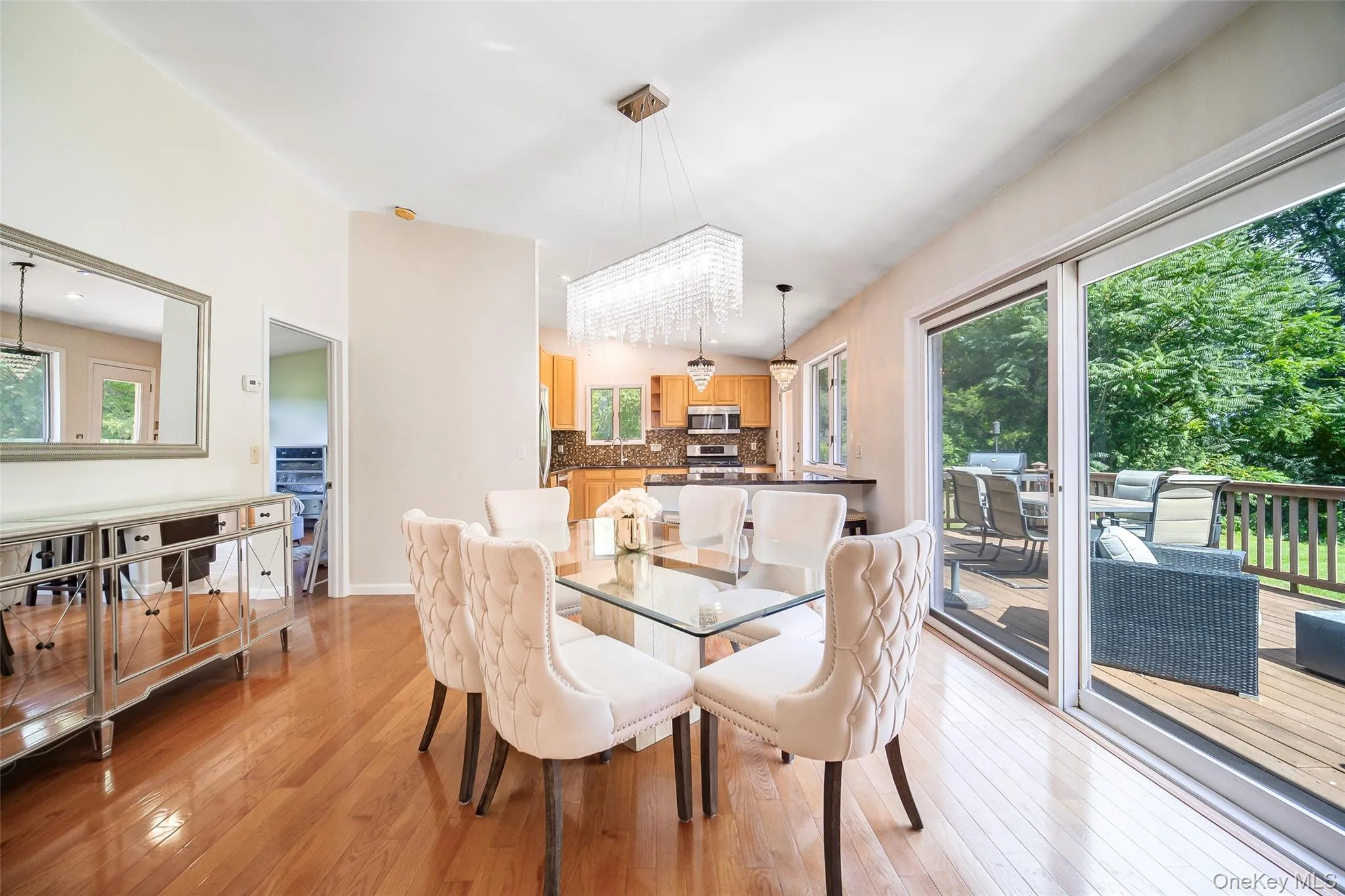 Vaulted ceilings, hardwood flooring, and sliding glass doors to outdoor decking Vaulted ceilings, hardwood flooring, and sliding glass doors to outdoor decking