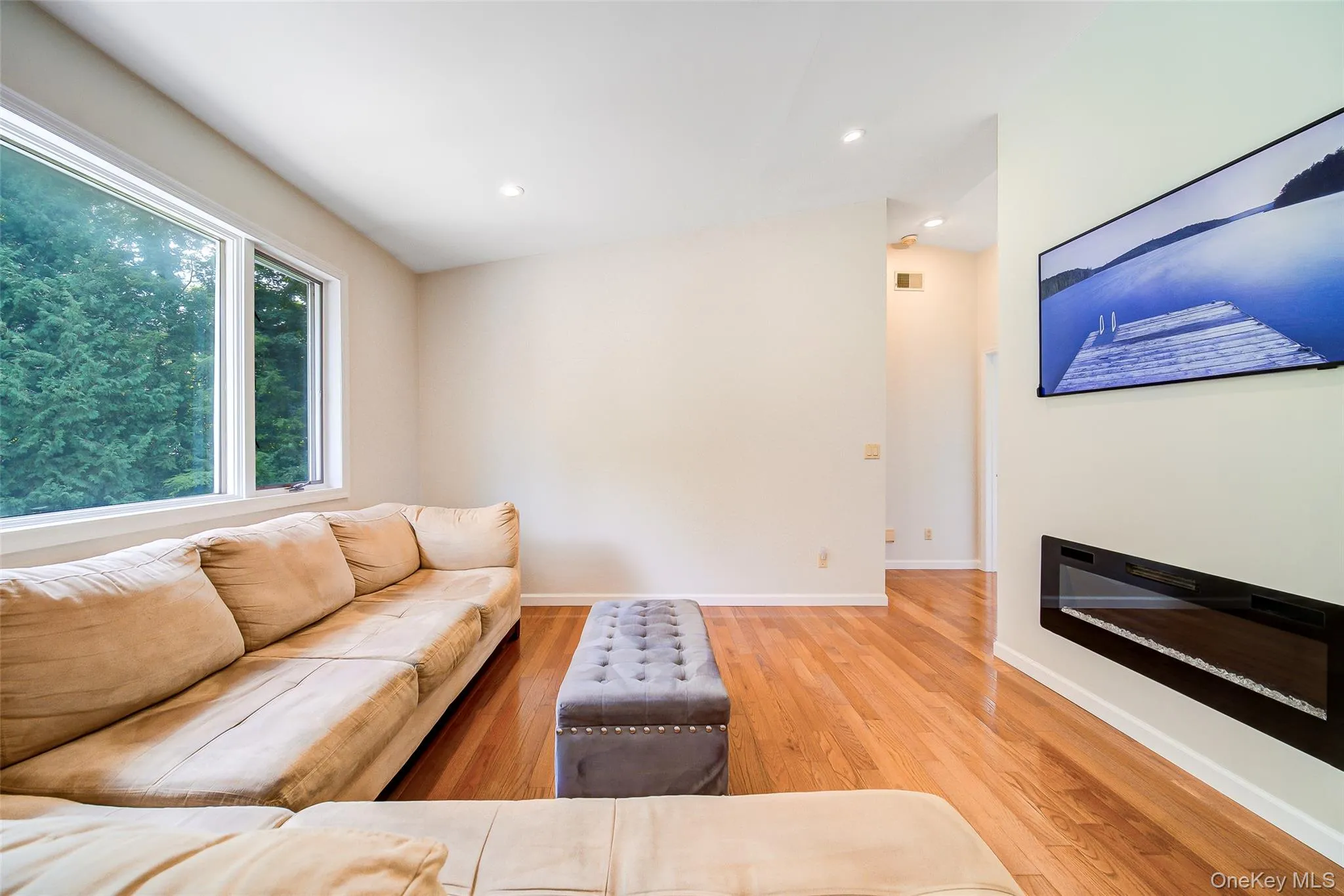 Hardwood flooring, recessed lighting, and large windows Hardwood flooring, recessed lighting, and large windows