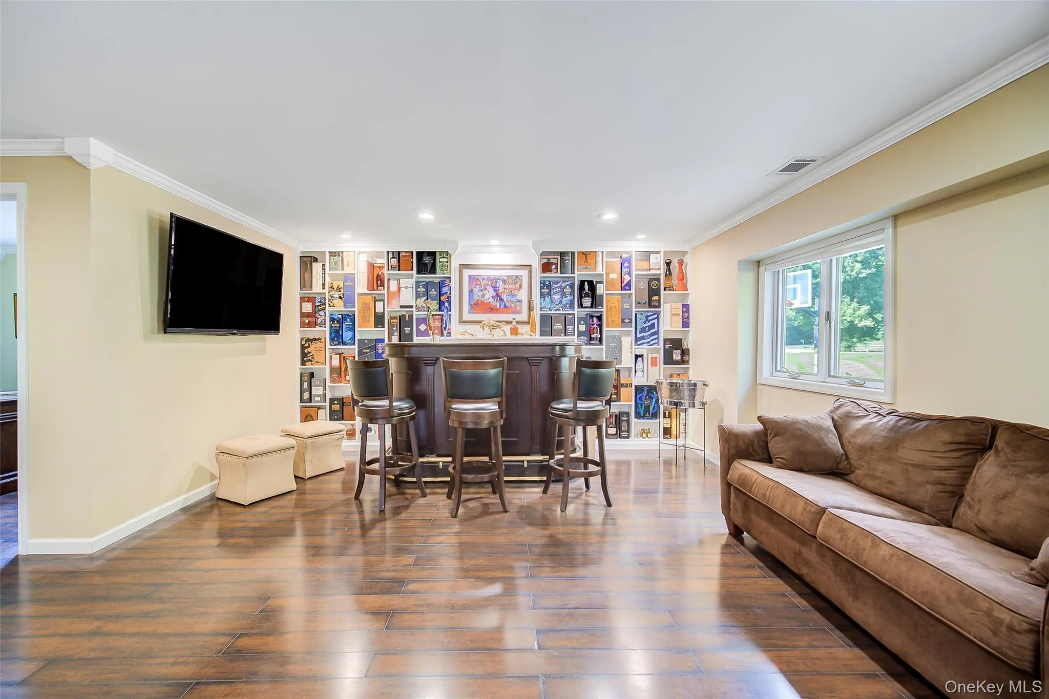 Custom built in shelving in entertainment area with walk-out to yard and drive Custom built in shelving in entertainment area with walk-out to yard and drive
