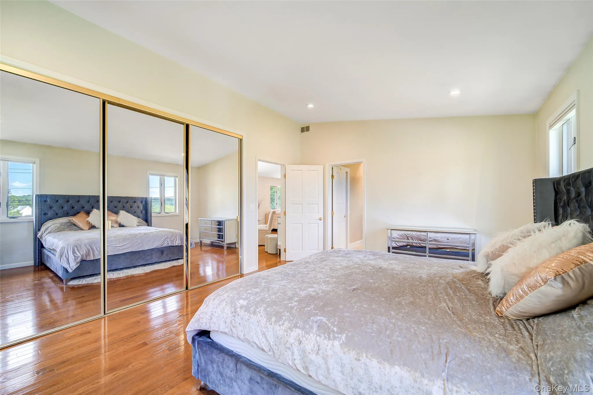 Hardwood flooring, recessed lighting, mirrored closet doors, paneled interior doors, and white trim Hardwood flooring, recessed lighting, mirrored closet doors, paneled interior doors, and white trim
