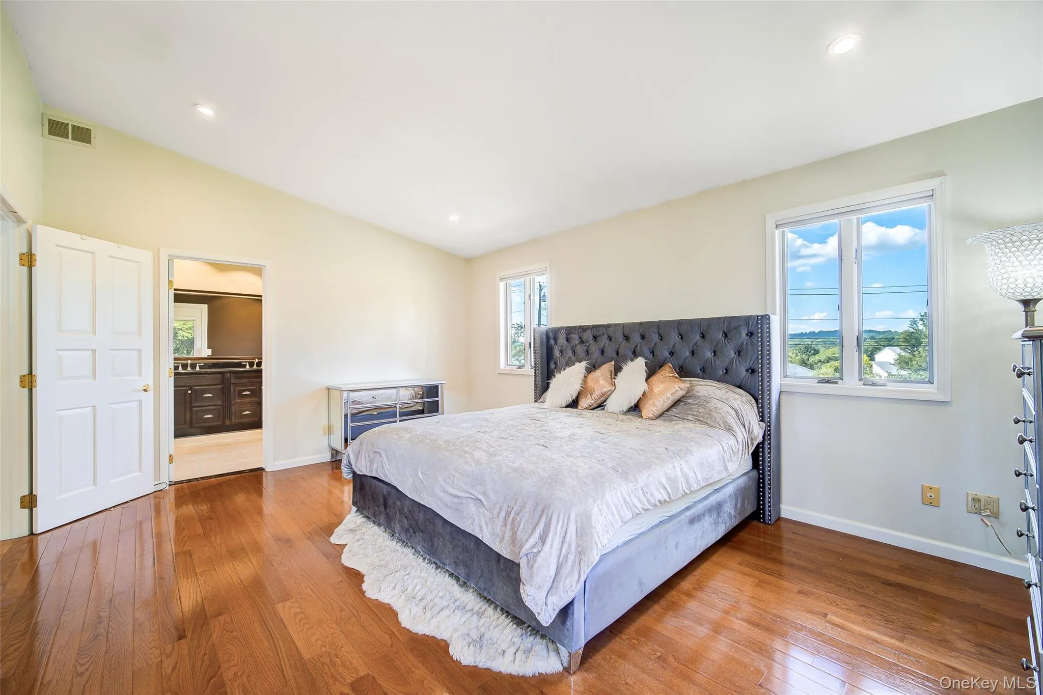 Hardwood flooring, vaulted ceiling, recessed lighting, and a double window Hardwood flooring, vaulted ceiling, recessed lighting, and a double window