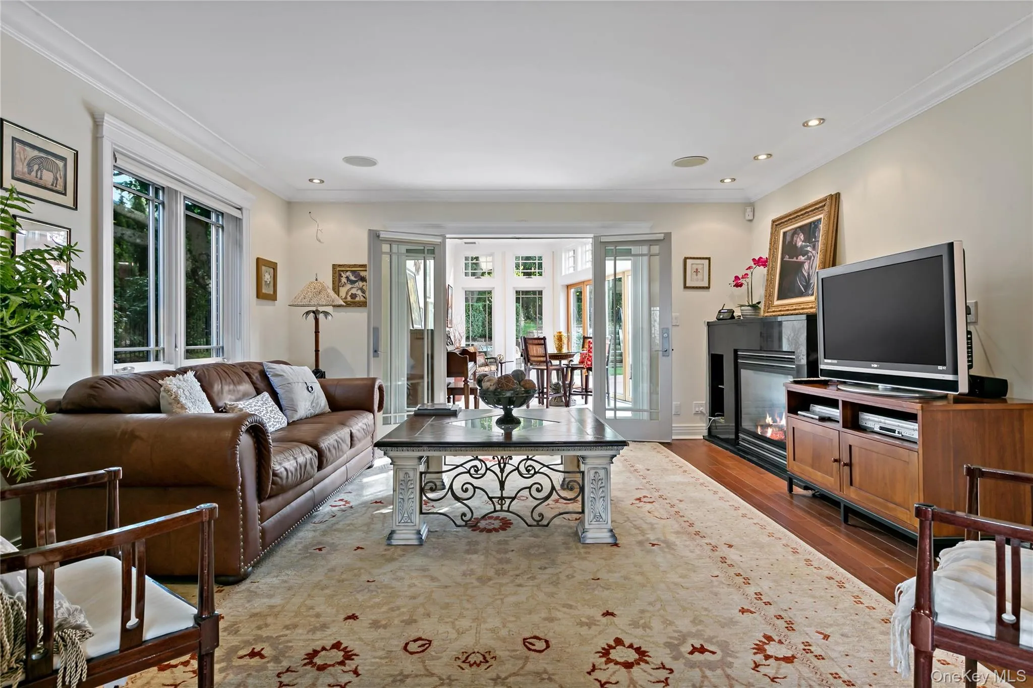 Media Room features Double-Sided Gas Fireplace and Glass French Doors Leading to the Sun Room Media Room features Double-Sided Gas Fireplace and Glass French Doors Leading to the Sun Room
