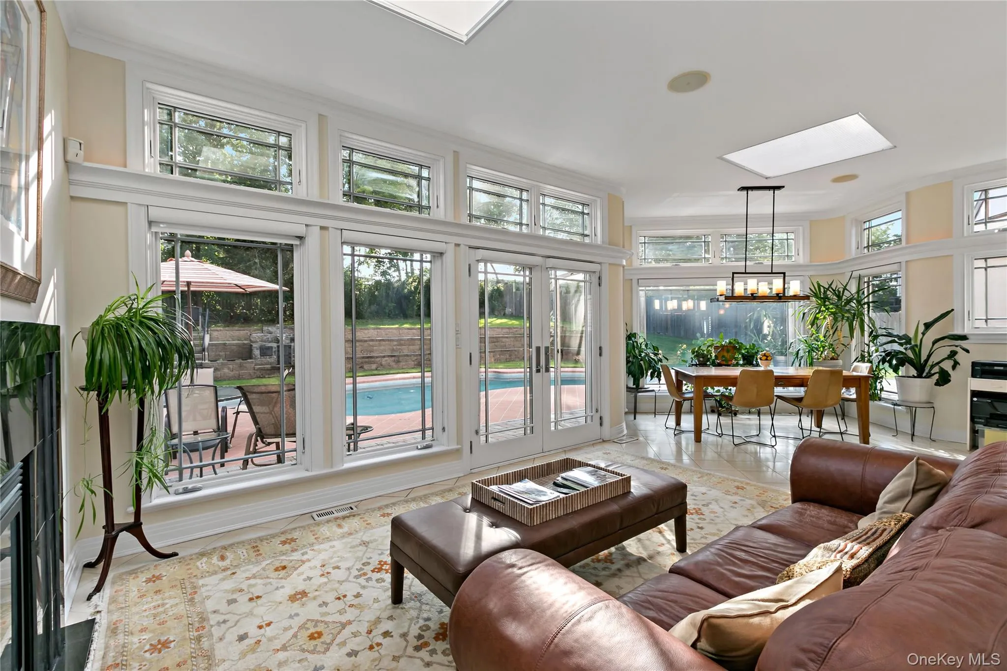 Family Room features a Skylight and Double-Sided Gas Fireplace. Enjoy Easy Access to the Patio Family Room features a Skylight and Double-Sided Gas Fireplace. Enjoy Easy Access to the Patio