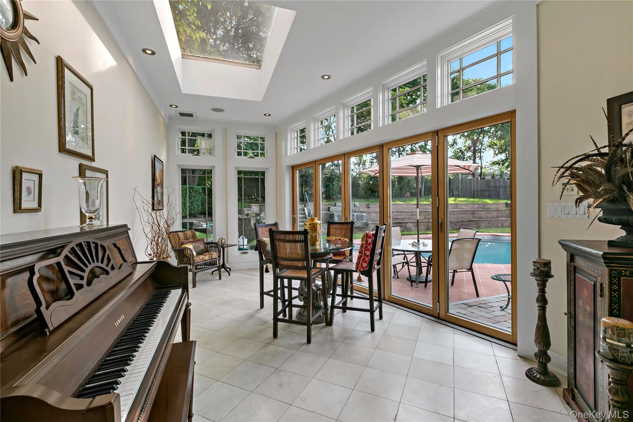 Sun Room features a Sky Light and Accordion Glass Doors leading to the Patio and Pool Sun Room features a Sky Light and Accordion Glass Doors leading to the Patio and Pool