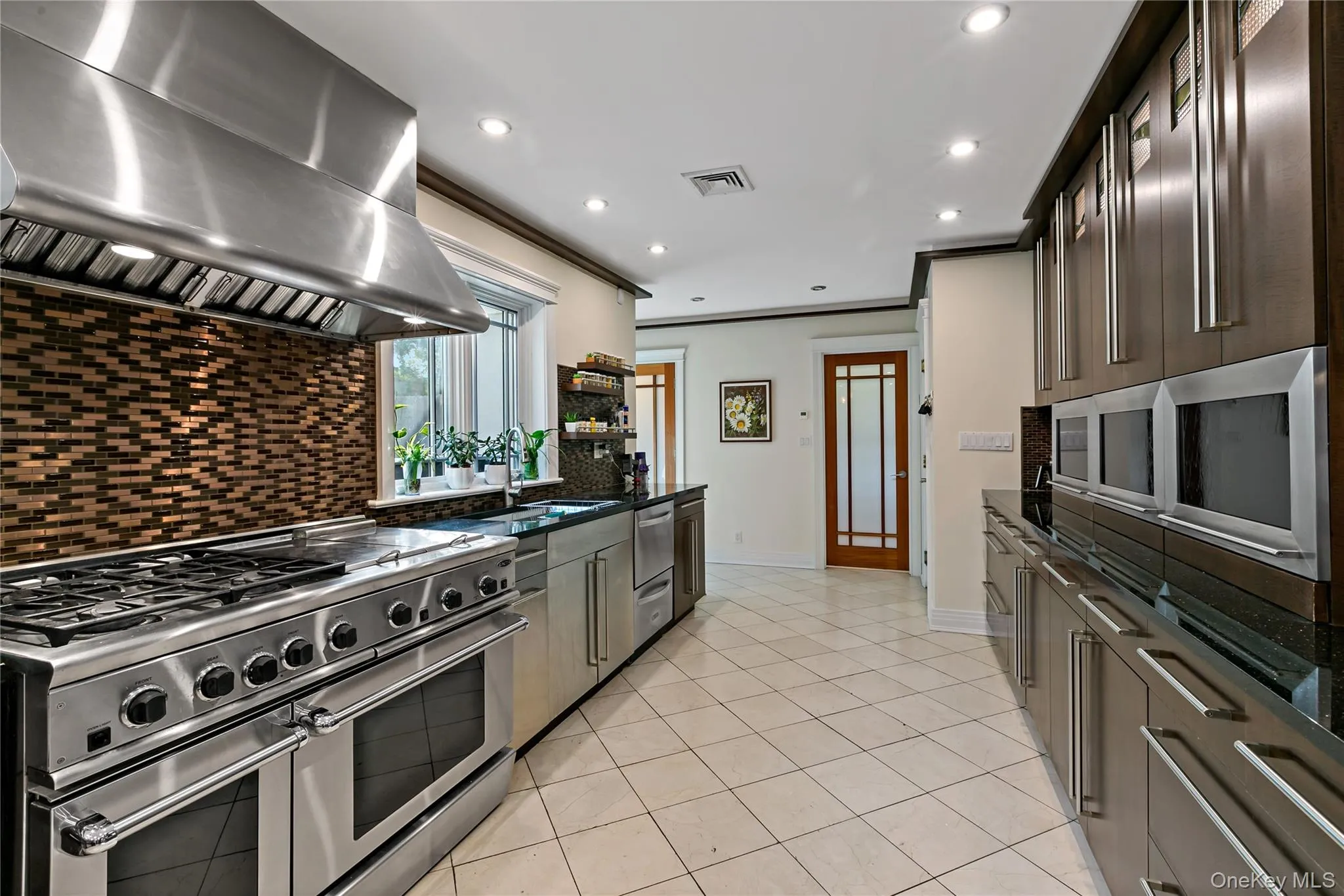 Gourmet Kitchen featuring High End Appliances including a Miele Built-in Coffee Machine, Wine Fridge and Two Beverage Fridges Gourmet Kitchen featuring High End Appliances including a Miele Built-in Coffee Machine, Wine Fridge and Two Beverage Fridges
