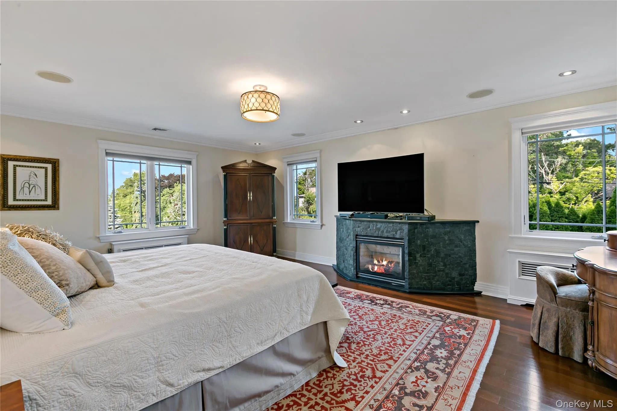 Primary Bedroom features a Gas Fireplace and Stunning Water Views Primary Bedroom features a Gas Fireplace and Stunning Water Views