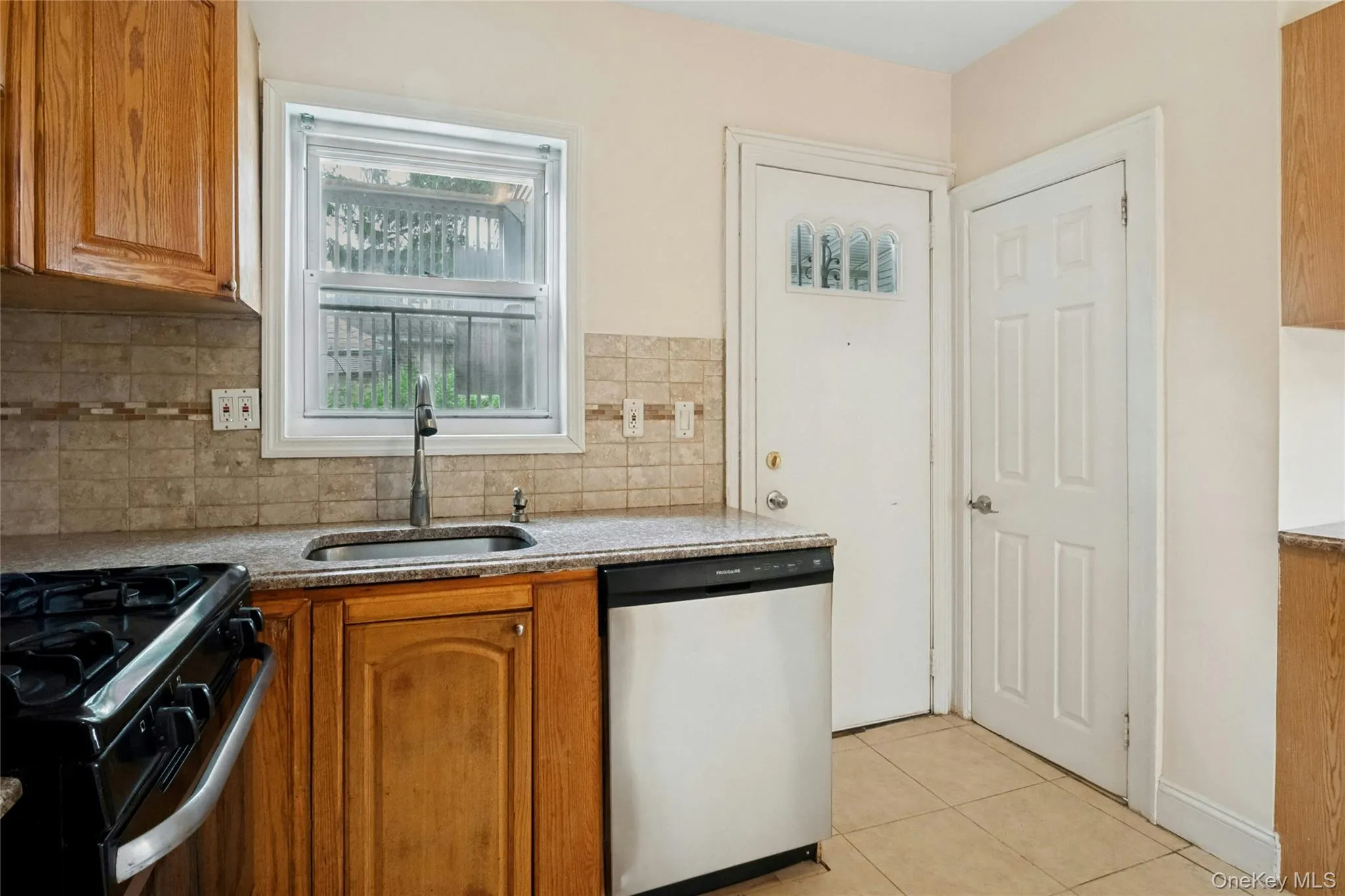 Kitchen with door to back yard and door to half bath Kitchen with door to back yard and door to half bath