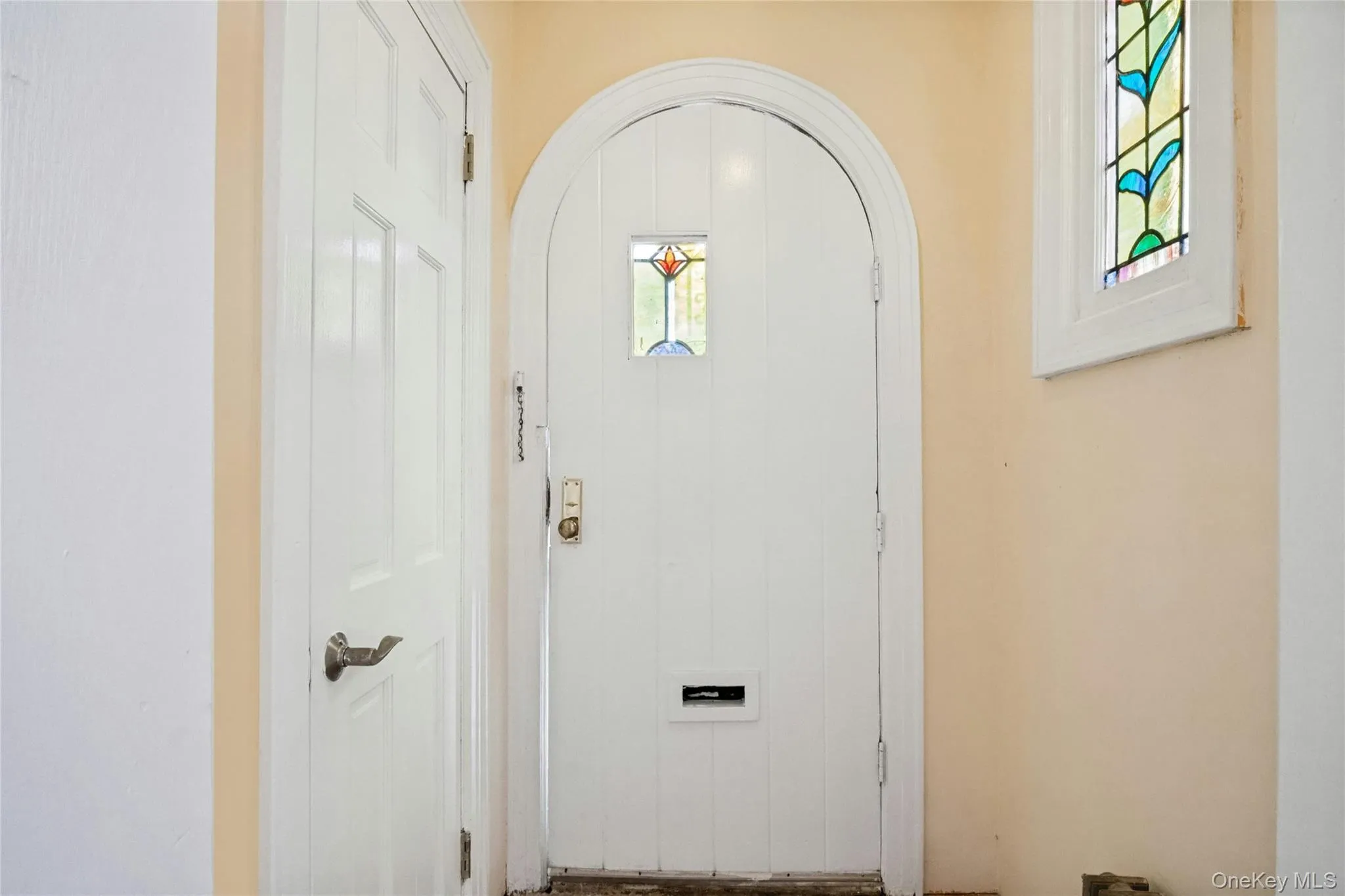 Foyer with closet and stain glass window Foyer with closet and stain glass window
