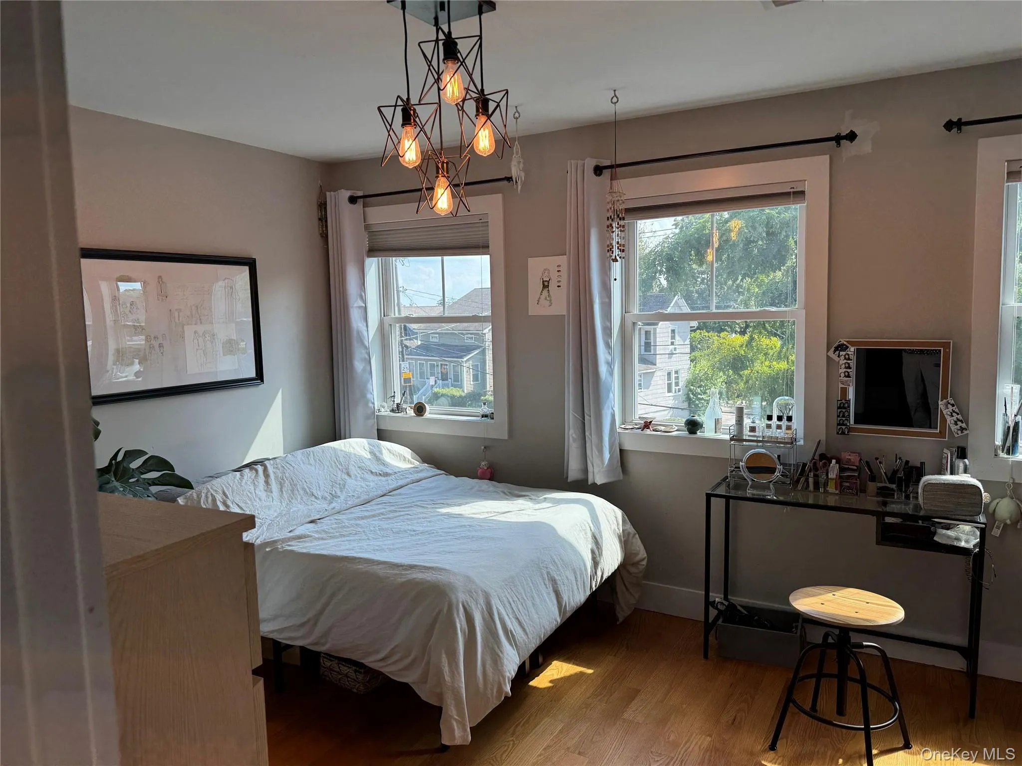 Bedroom featuring wood finished floors and baseboards Bedroom featuring wood finished floors and baseboards
