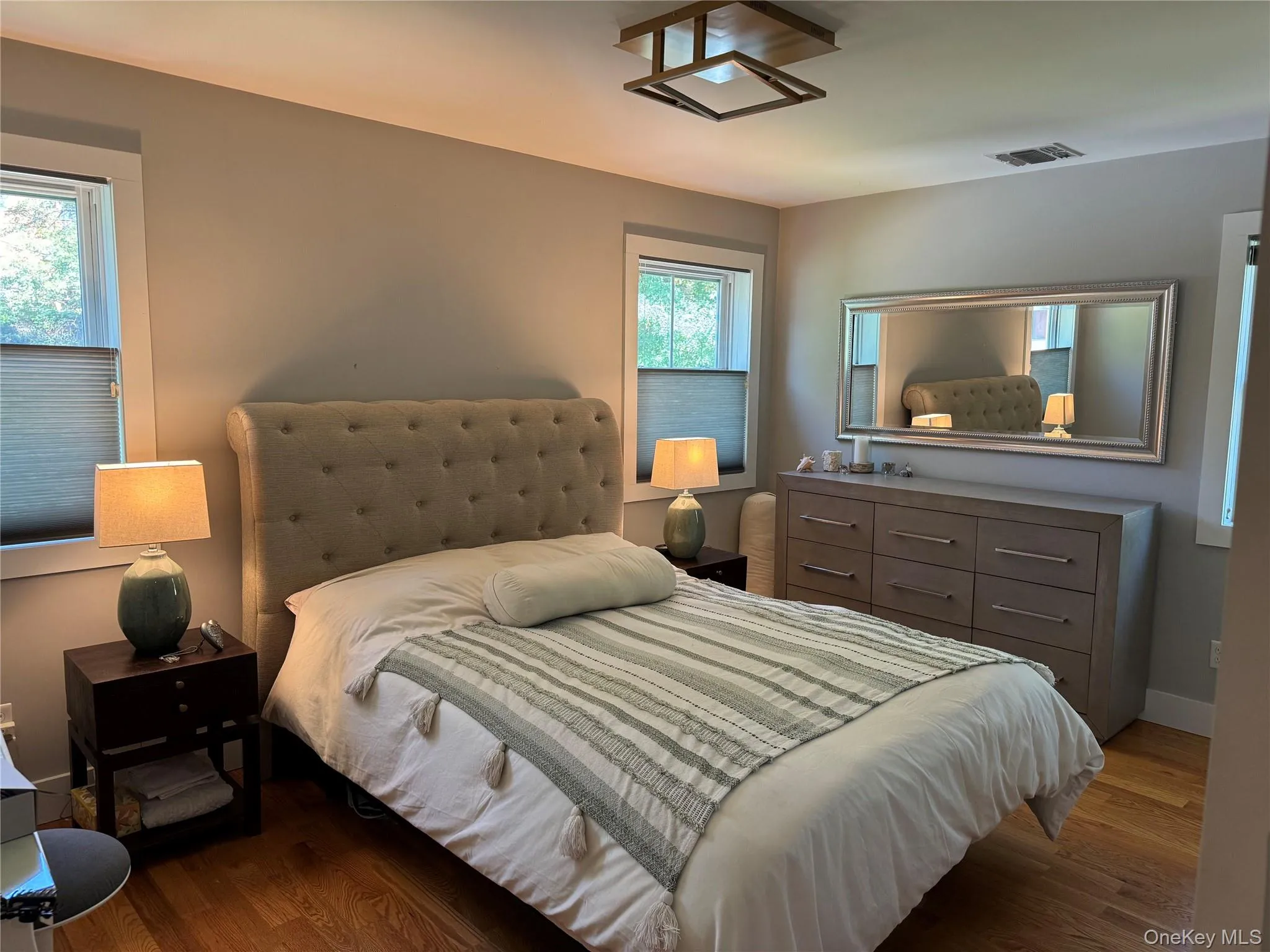 Bedroom featuring dark wood finished floors Bedroom featuring dark wood finished floors