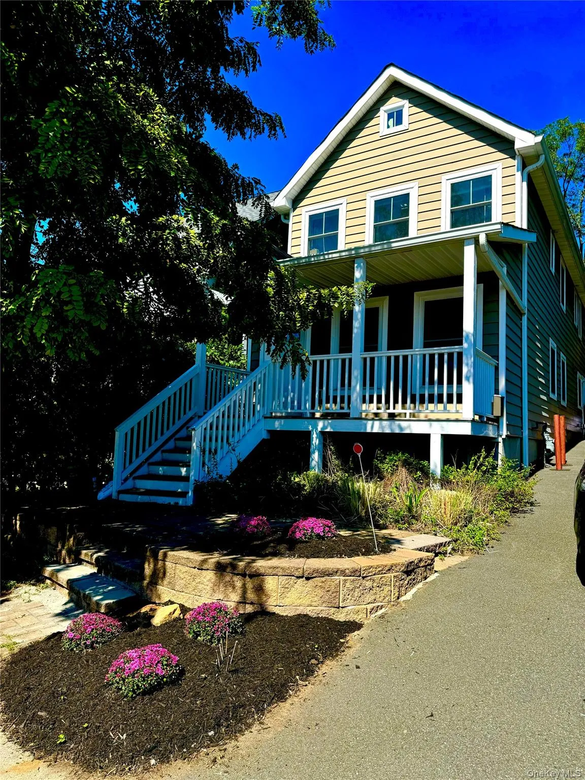 View of front of property featuring a porch and stairway View of front of property featuring a porch and stairway