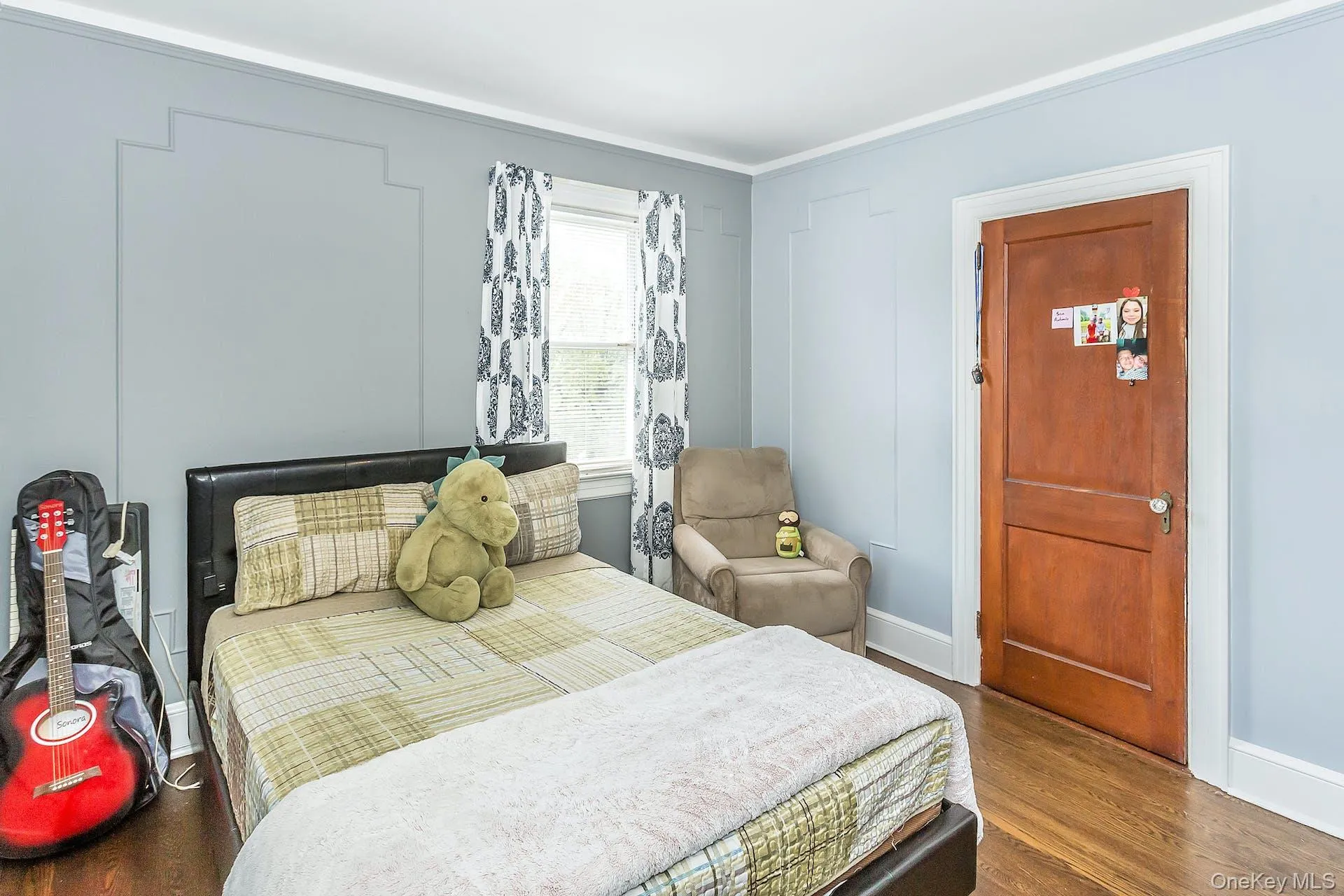 Hardwood flooring, crown molding, a built-in window, and a paneled door Hardwood flooring, crown molding, a built-in window, and a paneled door