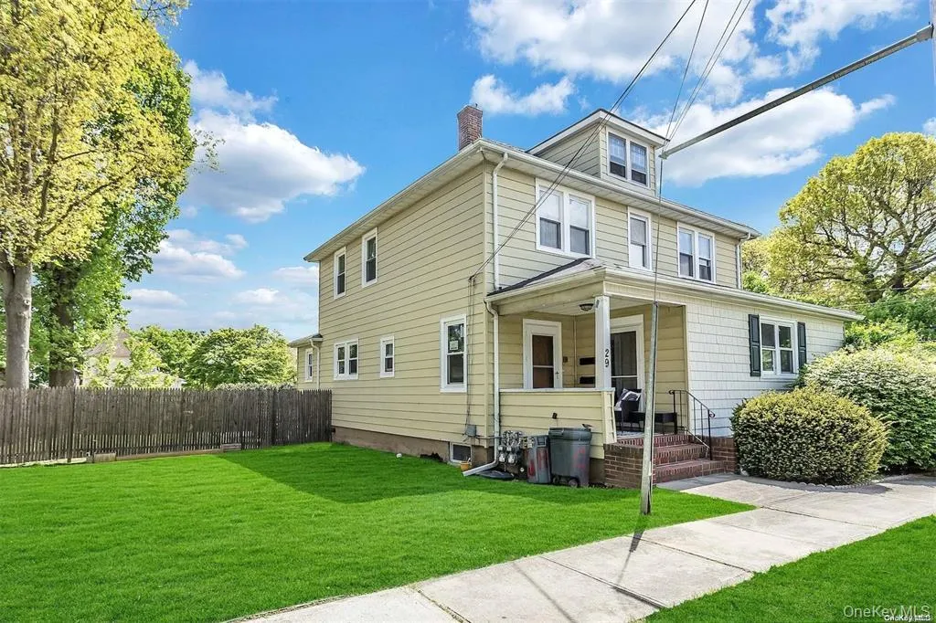 Two-story residence with a dormer and covered front entry Two-story residence with a dormer and covered front entry