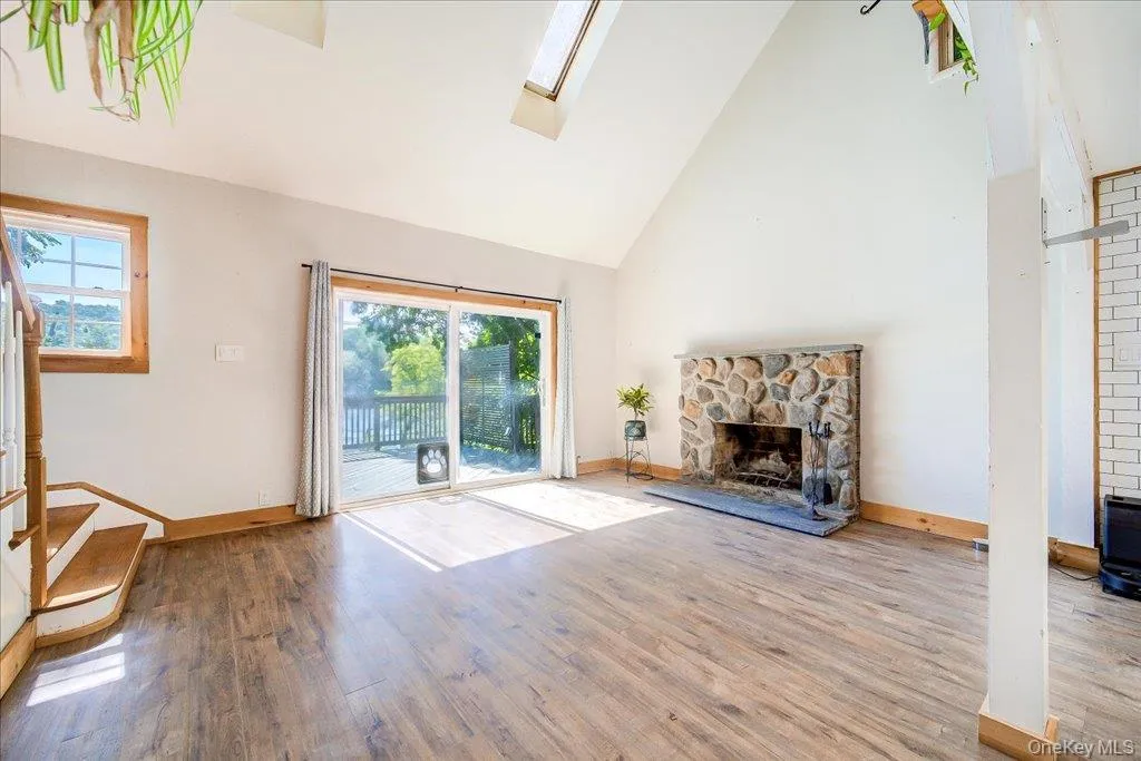 Living room with laminate flooring & wood burning fireplace. Living room with laminate flooring & wood burning fireplace.