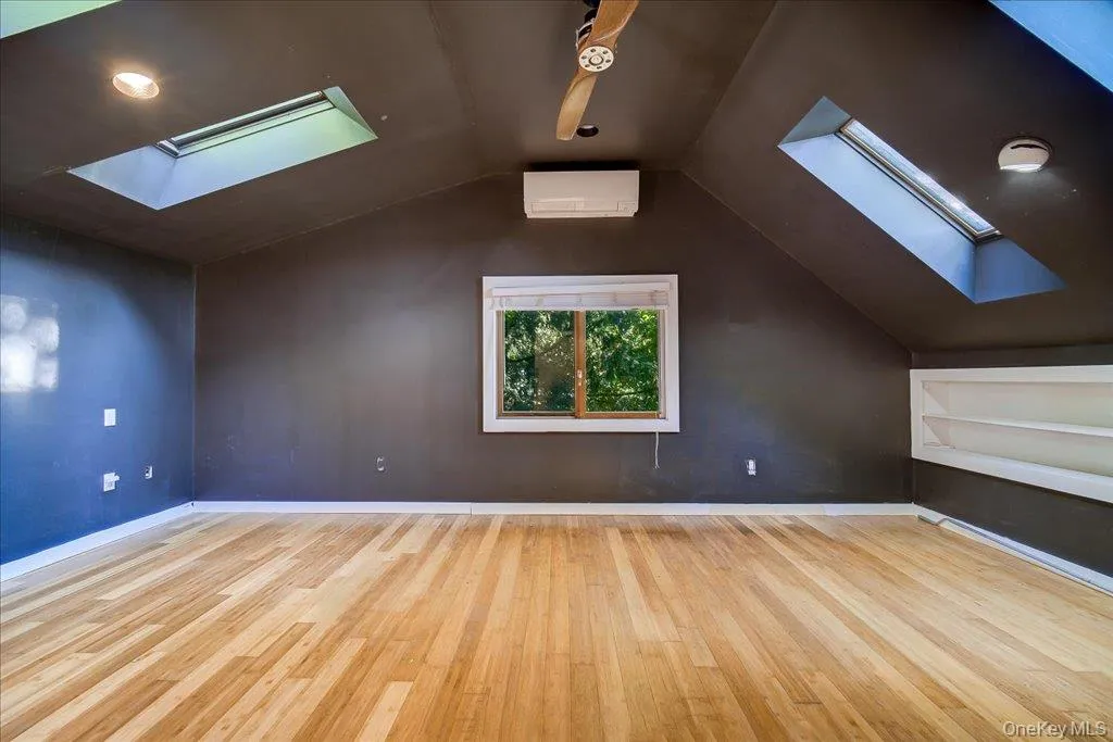 Large primary bedroom with skylights and private ensuite bathroom. Large primary bedroom with skylights and private ensuite bathroom.