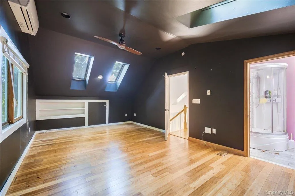 Large primary bedroom with skylights and private ensuite bathroom. Large primary bedroom with skylights and private ensuite bathroom.