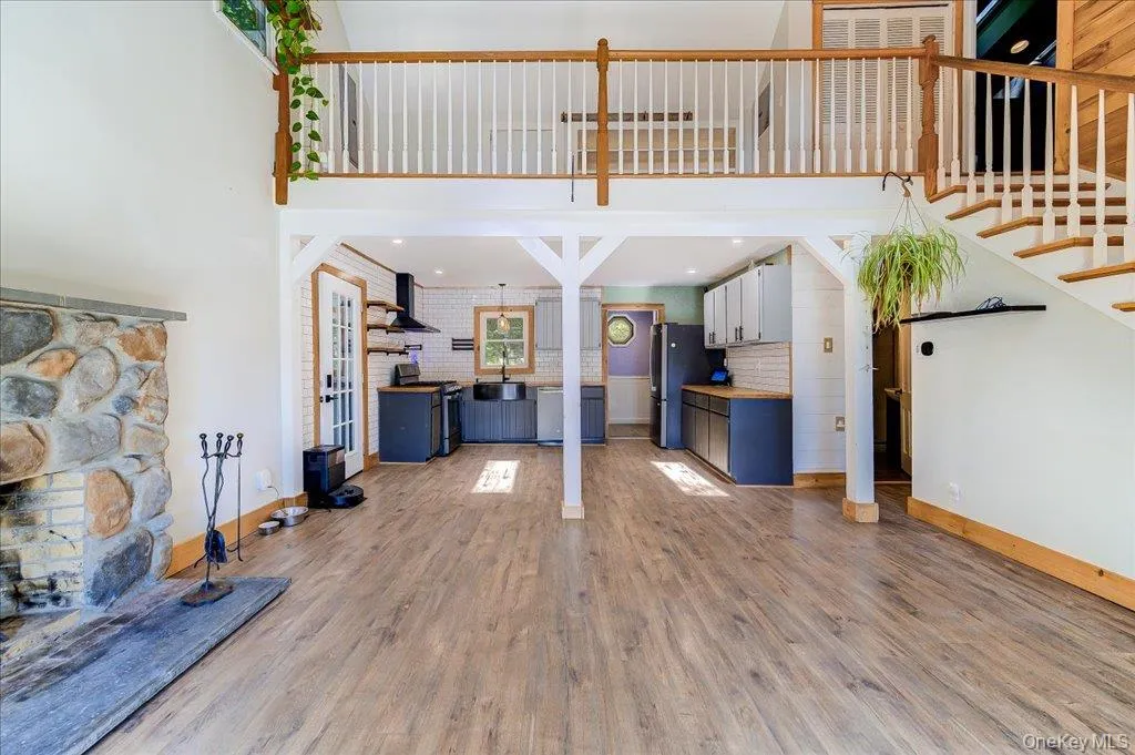 Living room with laminate flooring & wood burning fireplace. Living room with laminate flooring & wood burning fireplace.