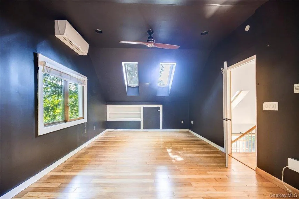 Large primary bedroom with skylights and private ensuite bathroom. Large primary bedroom with skylights and private ensuite bathroom.