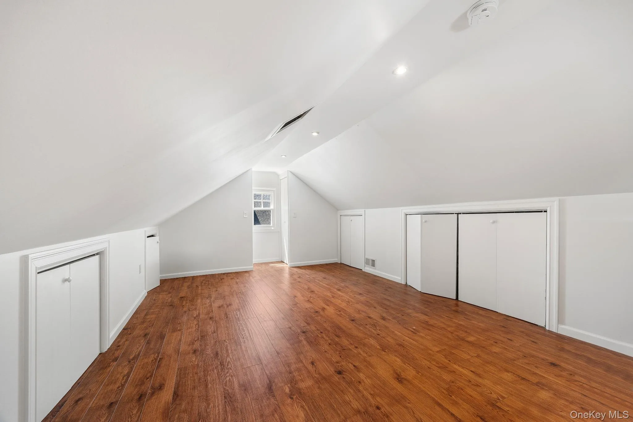 Additional living space featuring wood-type flooring and vaulted ceiling Additional living space featuring wood-type flooring and vaulted ceiling
