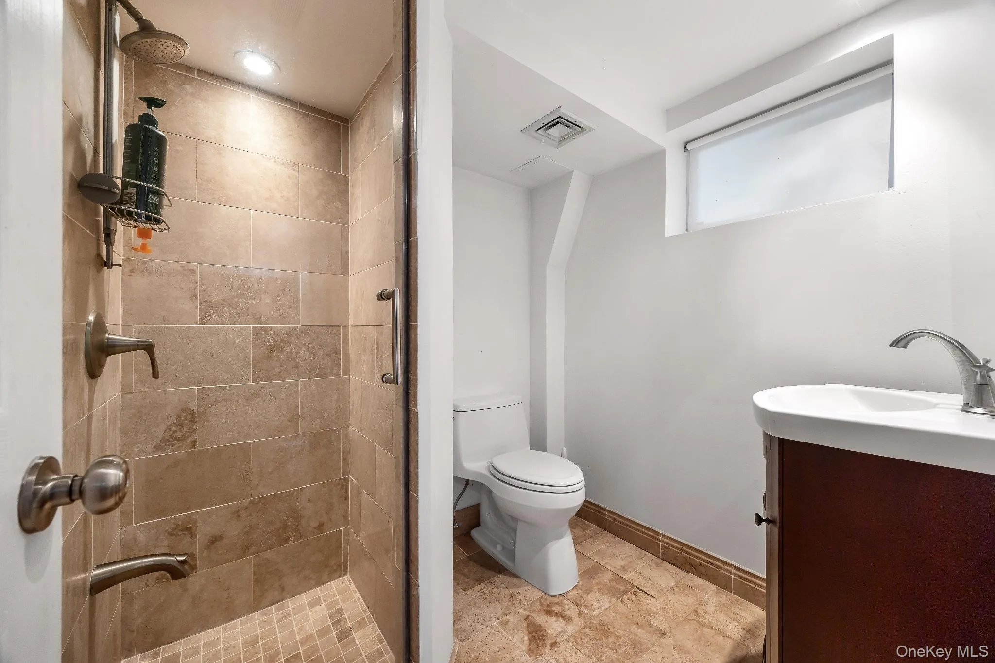 Full bathroom featuring vanity and a stall shower Full bathroom featuring vanity and a stall shower
