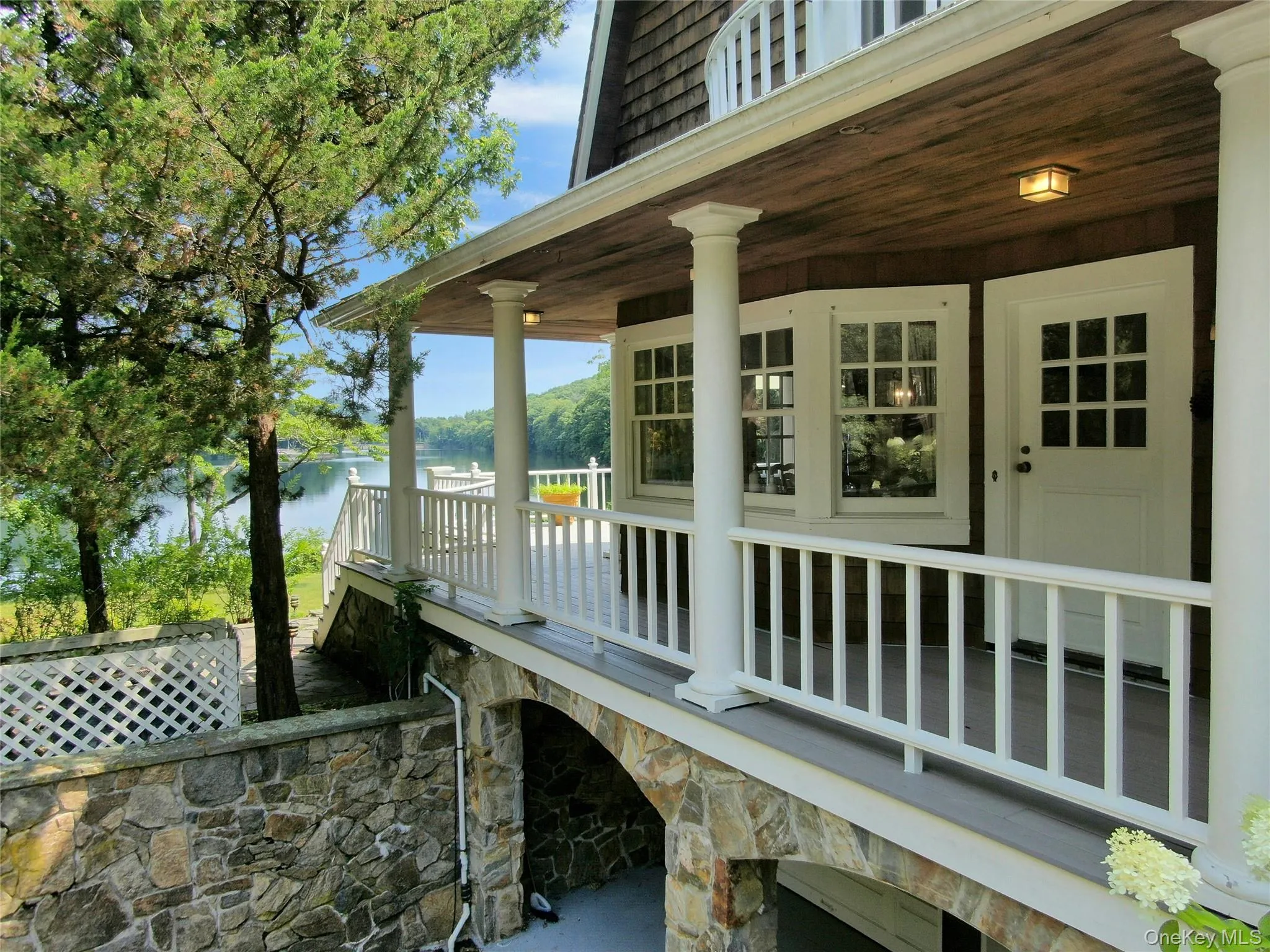 Side porch with lake views and garages Side porch with lake views and garages