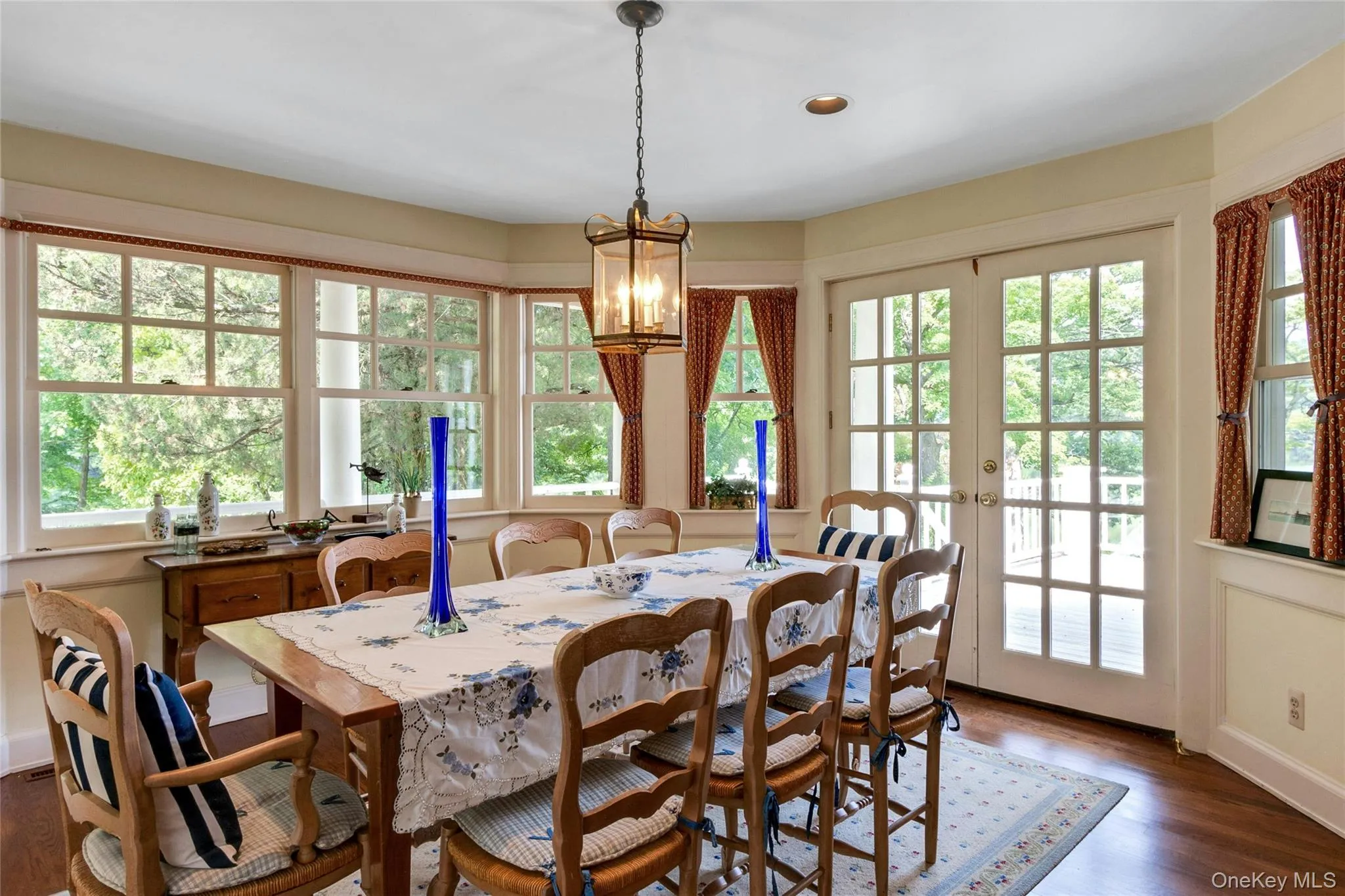 Kitchen - dining table with French doors opening to sun-filled porch Kitchen - dining table with French doors opening to sun-filled porch