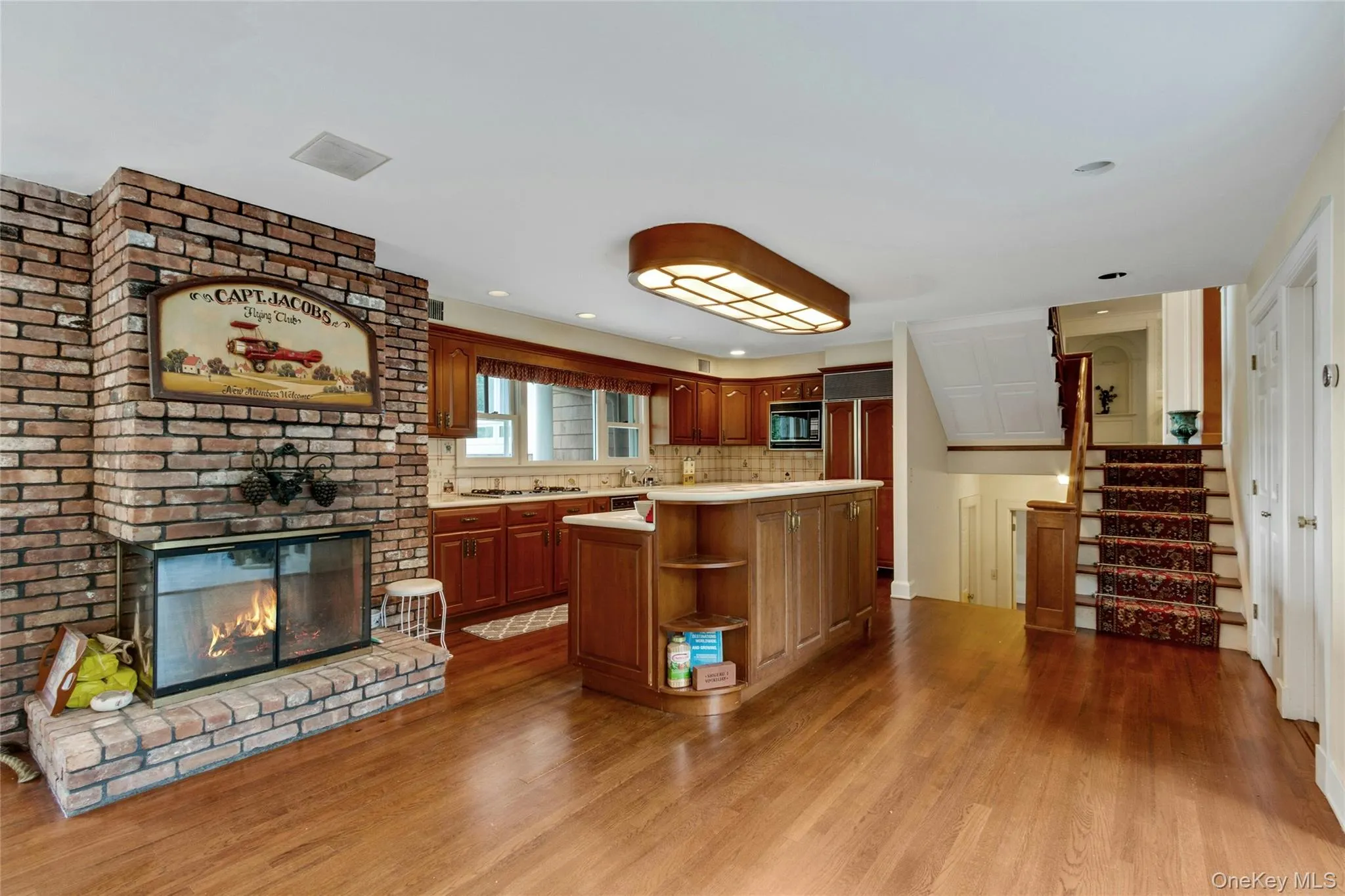 Kitchen - fireplace and stairs to front entrance and lower level living area and 2 bedrooms Kitchen - fireplace and stairs to front entrance and lower level living area and 2 bedrooms