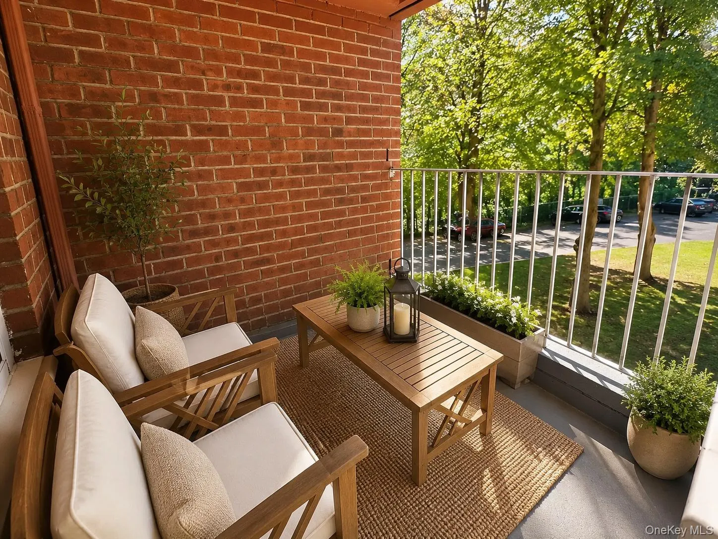Brick wall, gray floor, white metal railing, and a planter box Brick wall, gray floor, white metal railing, and a planter box