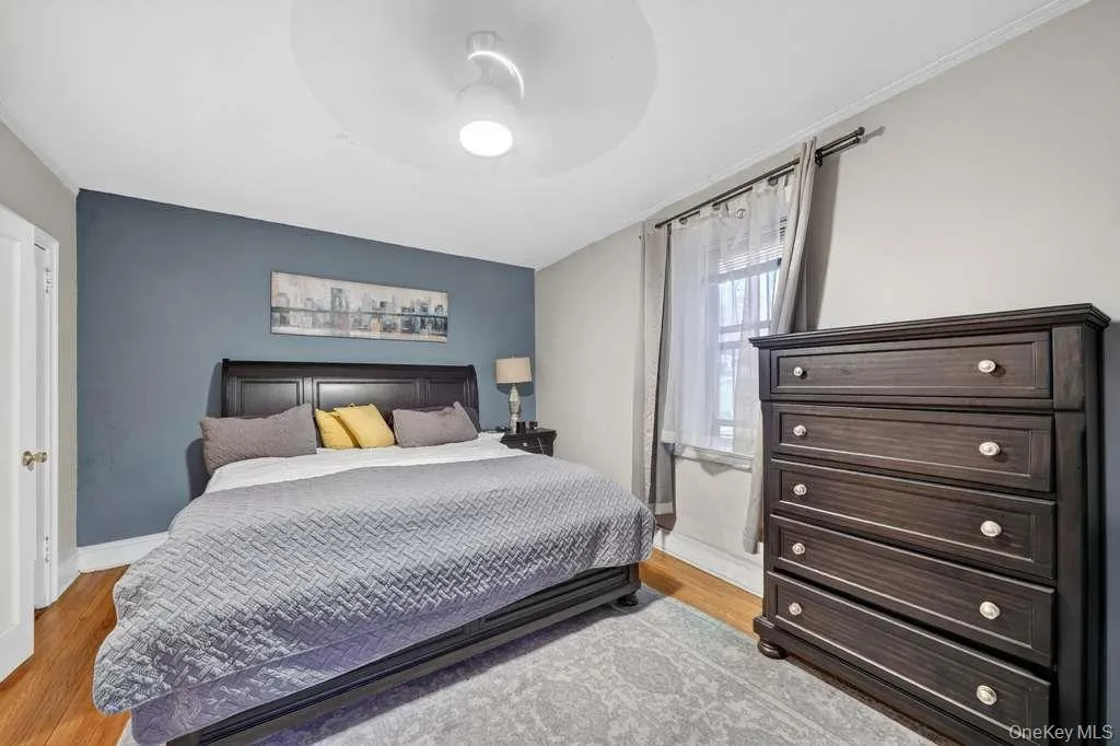 Bedroom featuring light wood-style floors and a ceiling fan Bedroom featuring light wood-style floors and a ceiling fan