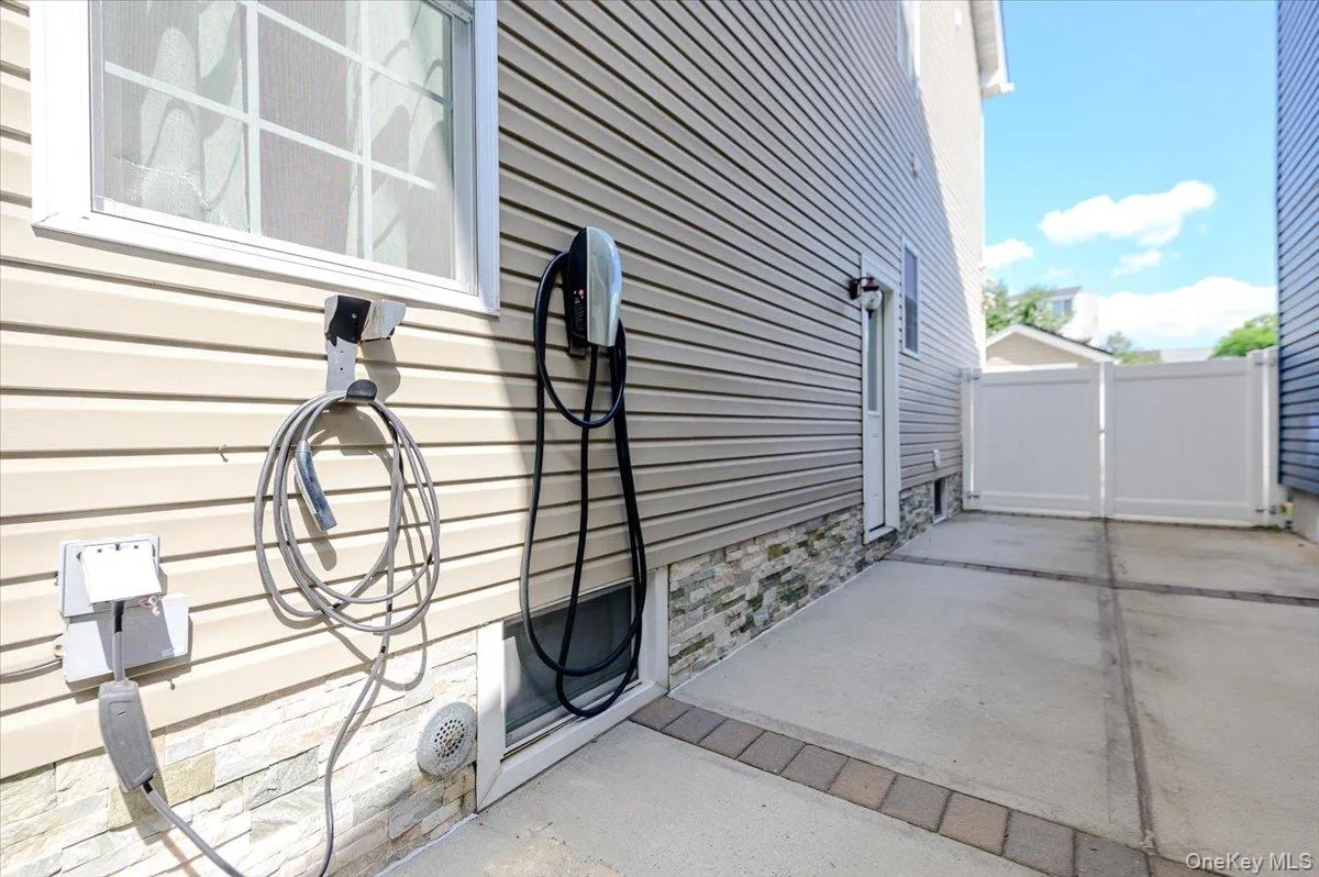 Private driveway with Tesla EV Charging station. Private driveway with Tesla EV Charging station.