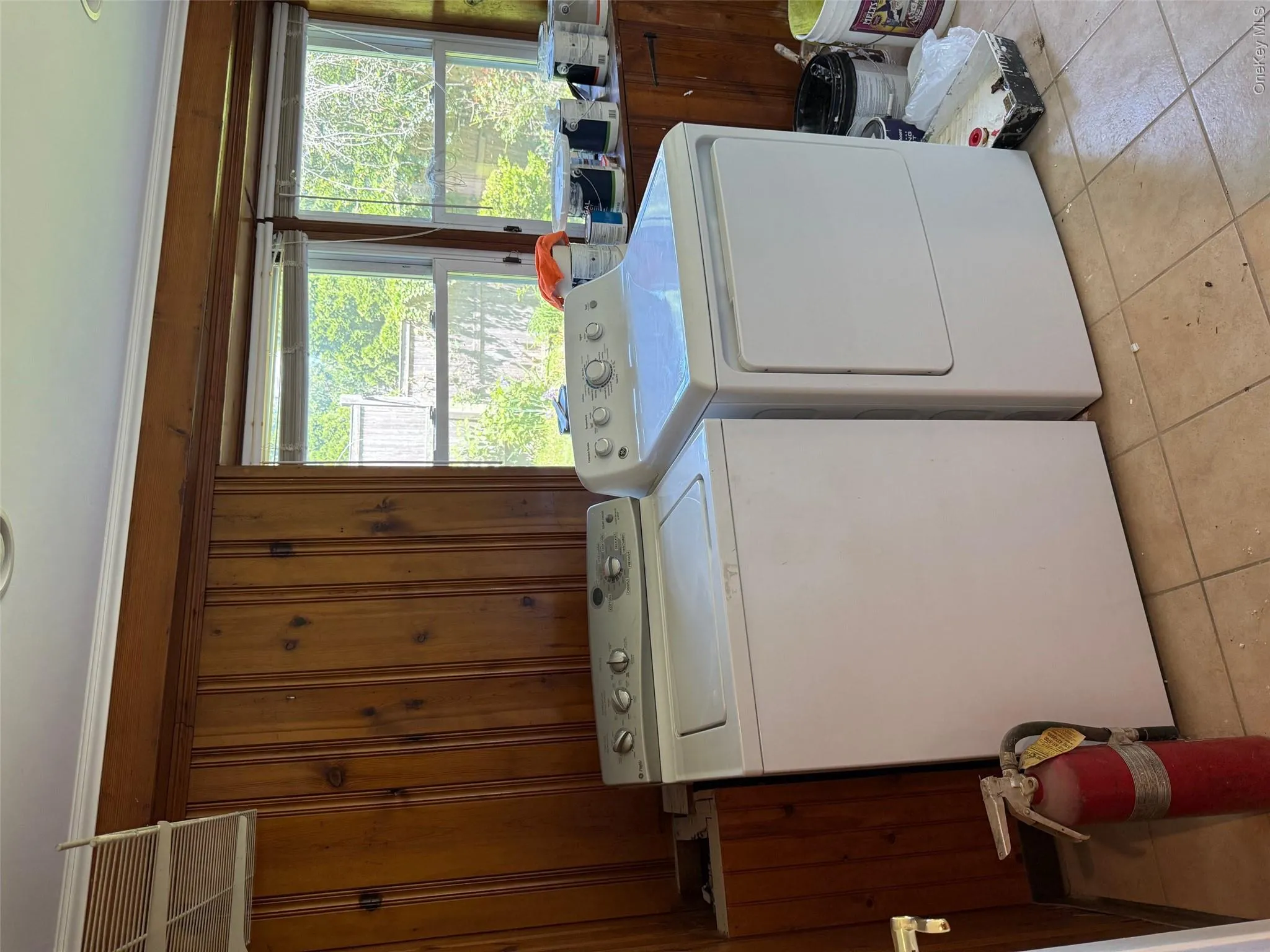 Laundry room featuring washing machine and dryer and light tile patterned floors Laundry room featuring washing machine and dryer and light tile patterned floors