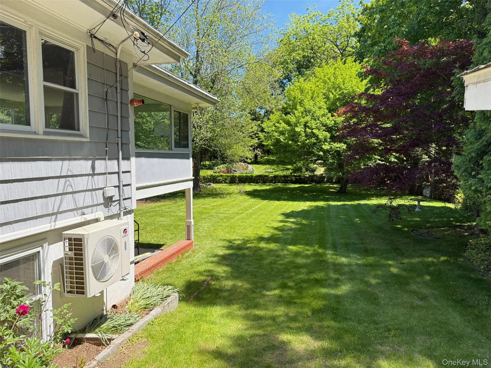 View of green lawn with ac unit View of green lawn with ac unit