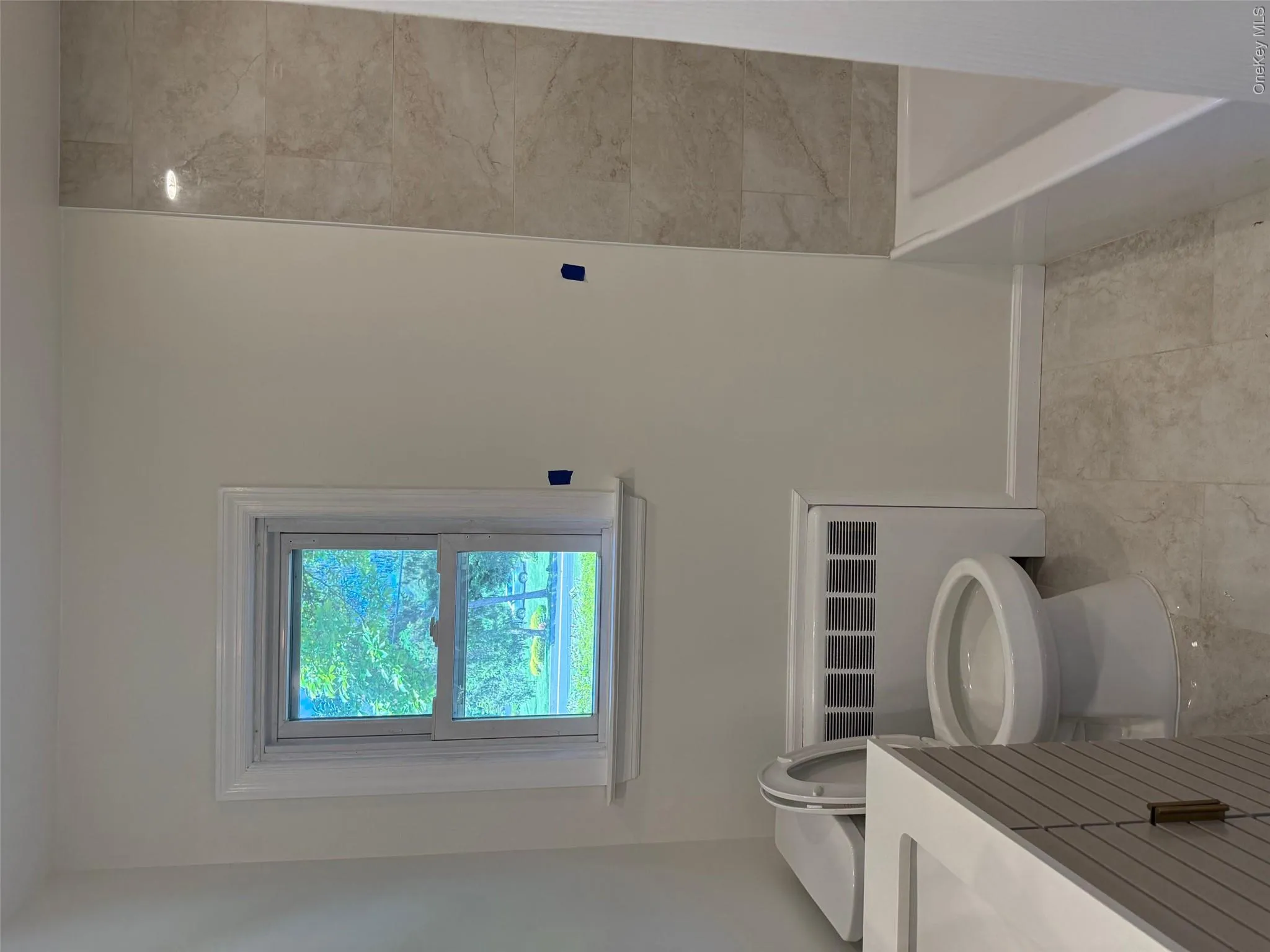Full bath featuring vanity, toilet, radiator heating unit, and baseboards Full bath featuring vanity, toilet, radiator heating unit, and baseboards