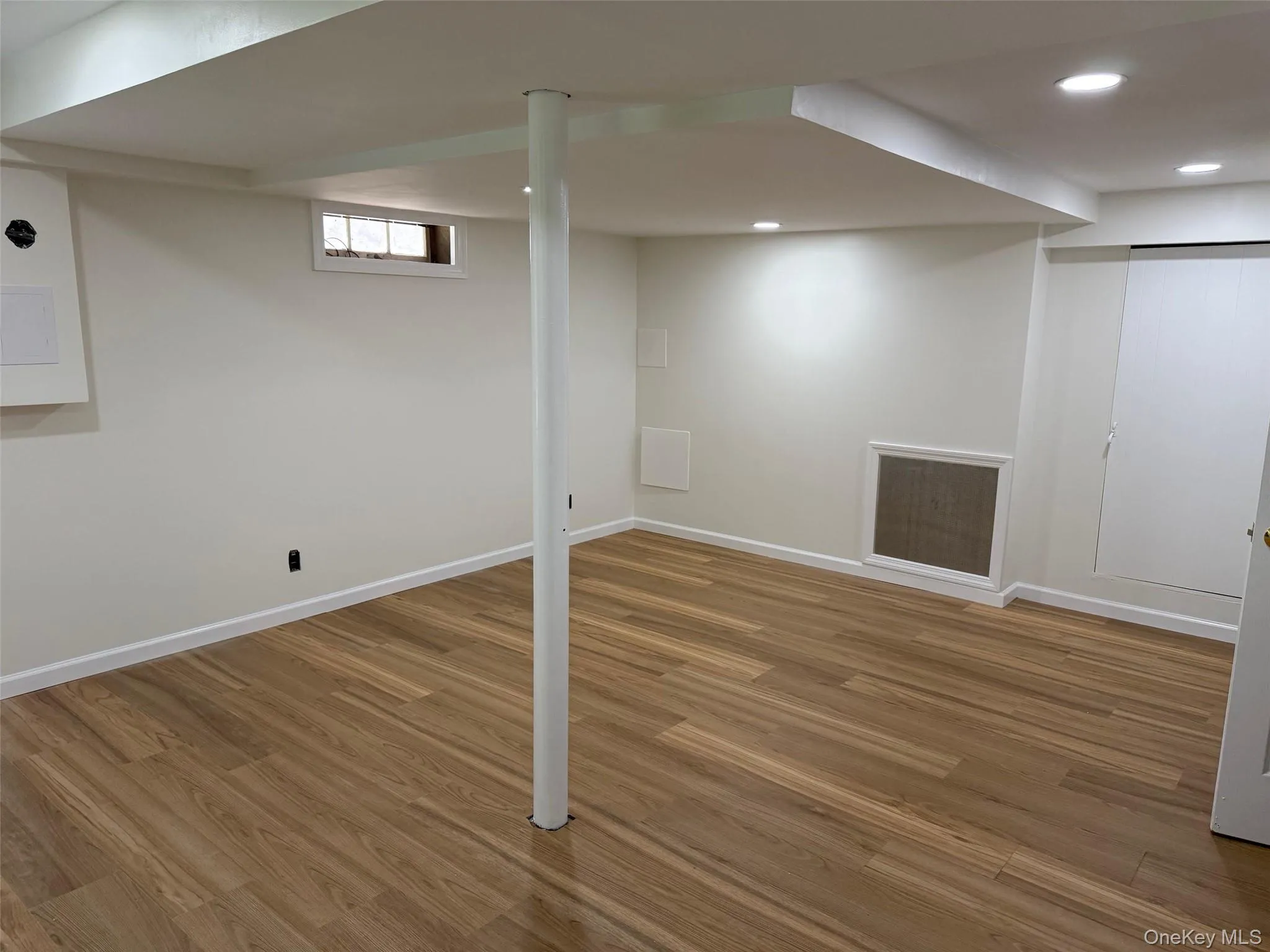 Basement with wood finished floors, baseboards, and recessed lighting Basement with wood finished floors, baseboards, and recessed lighting