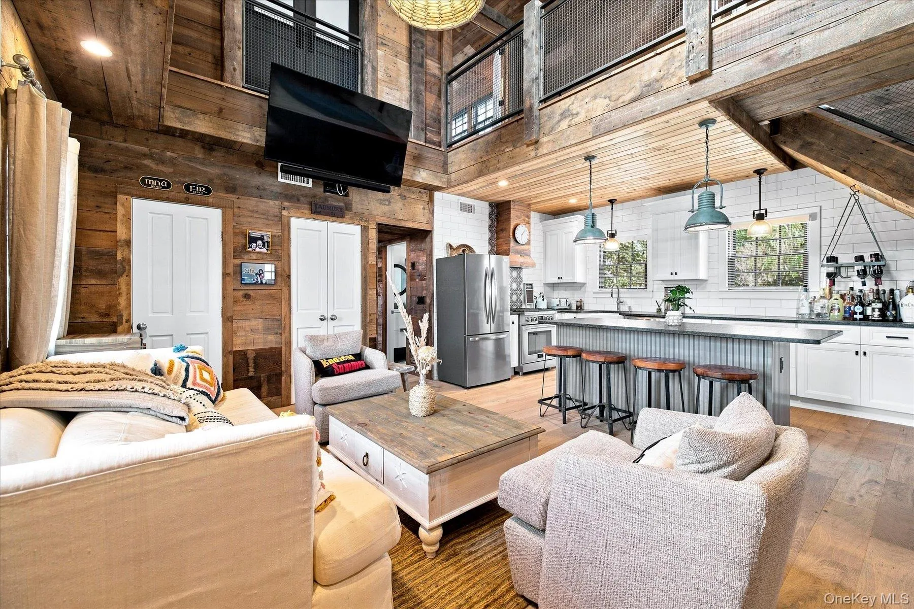 Open-concept living space with an exposed beam ceiling Open-concept living space with an exposed beam ceiling